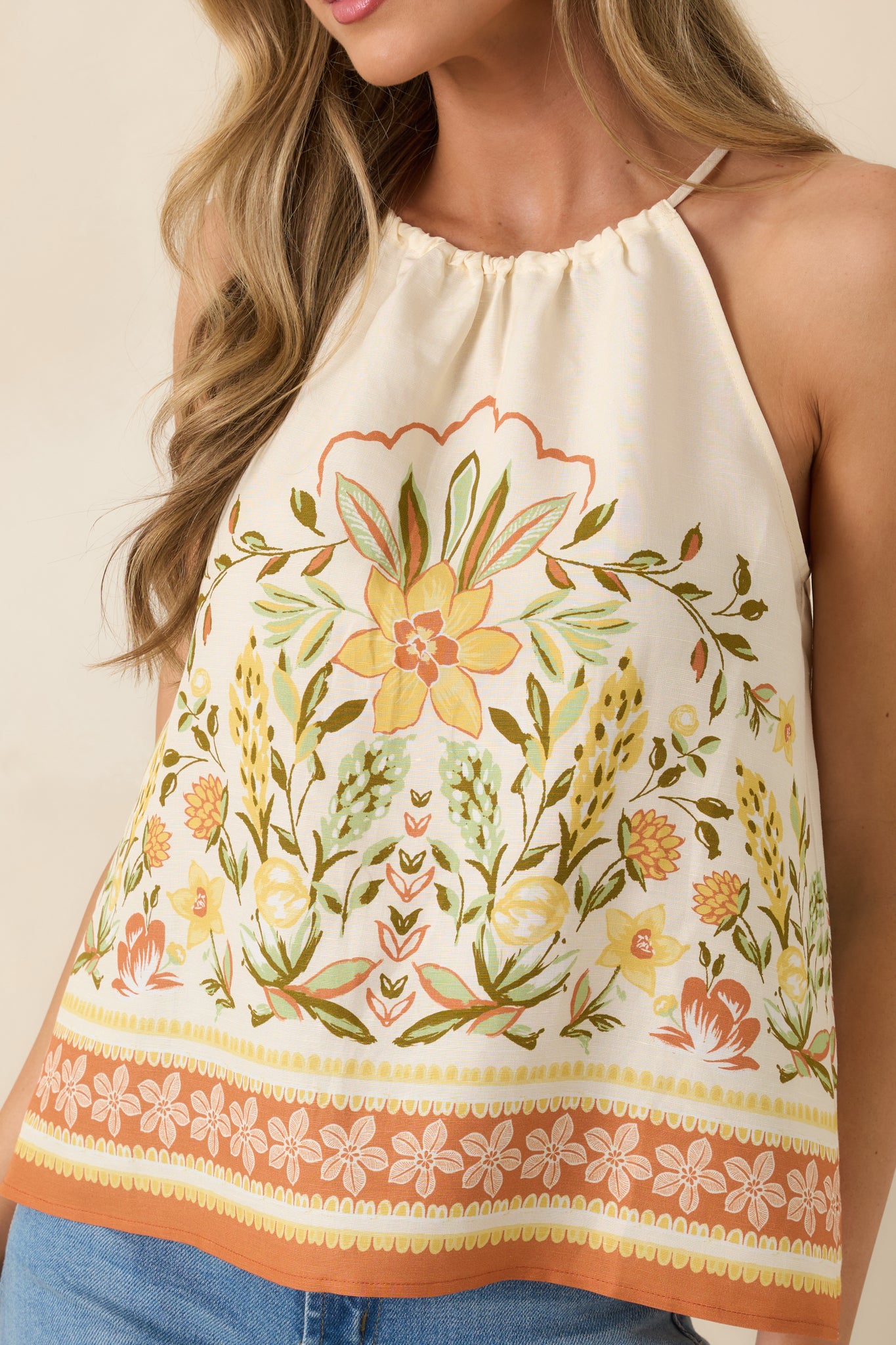 Detailed view of floral print in terracotta, golden yellow, and soft green