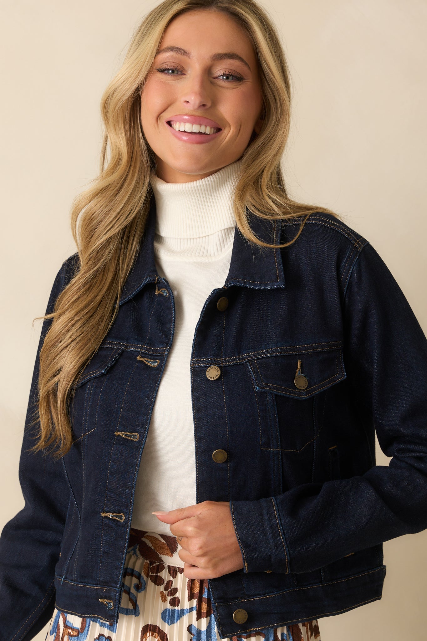 Detailed look at the collared neckline and front button placket of the denim jacket.