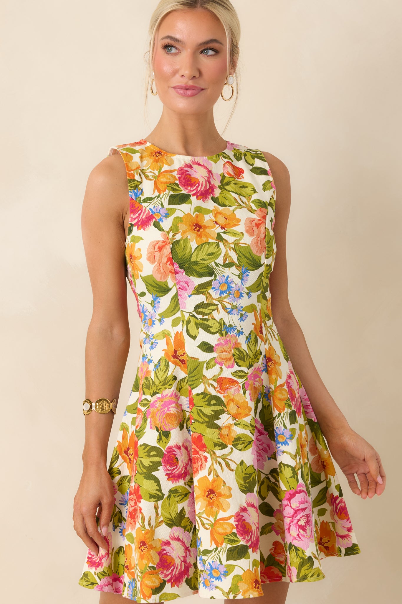 Detailed look at fitted bodice with bright floral design on an ivory background