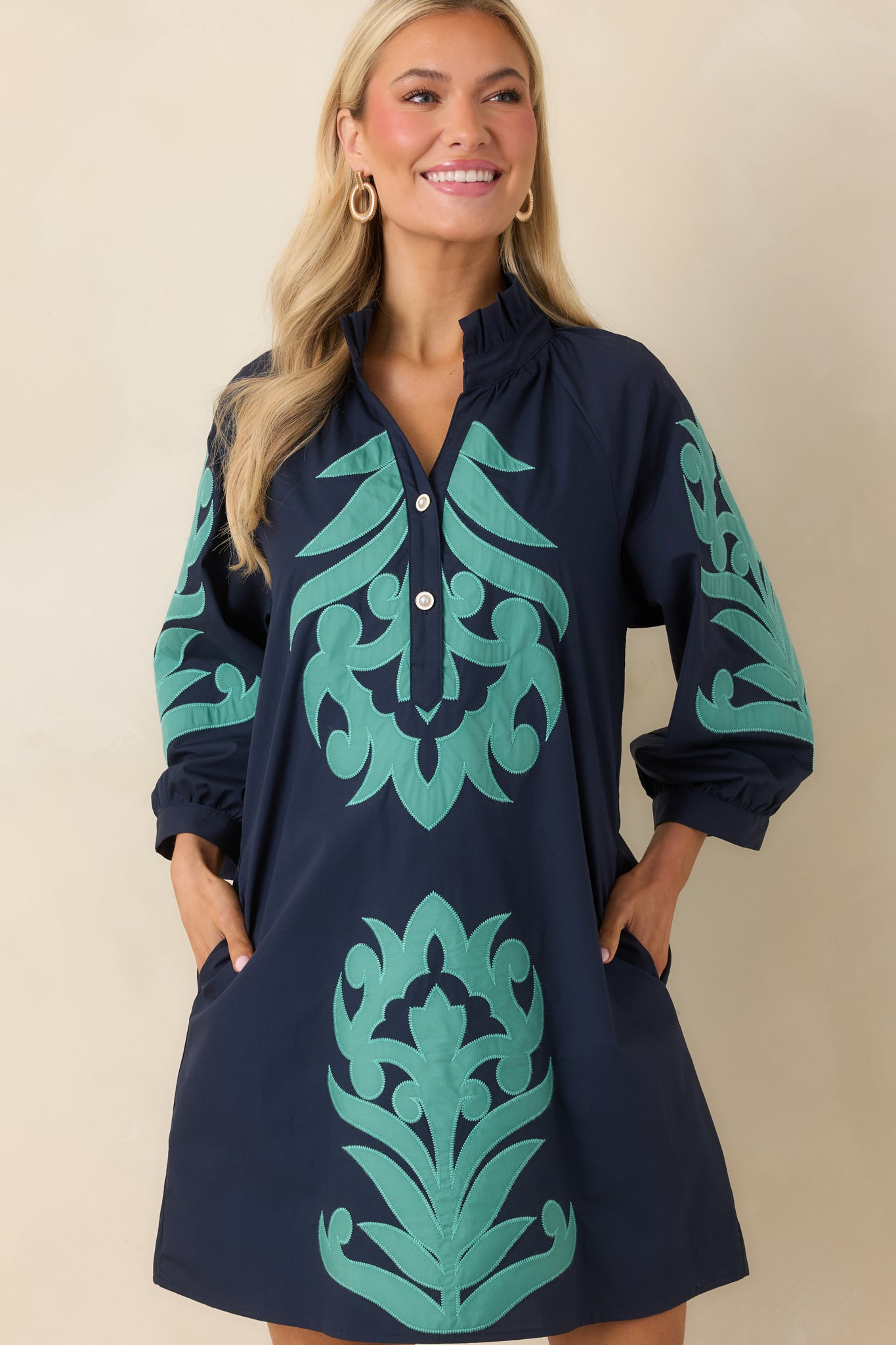 Detailed look at split neckline with subtle button accents.
