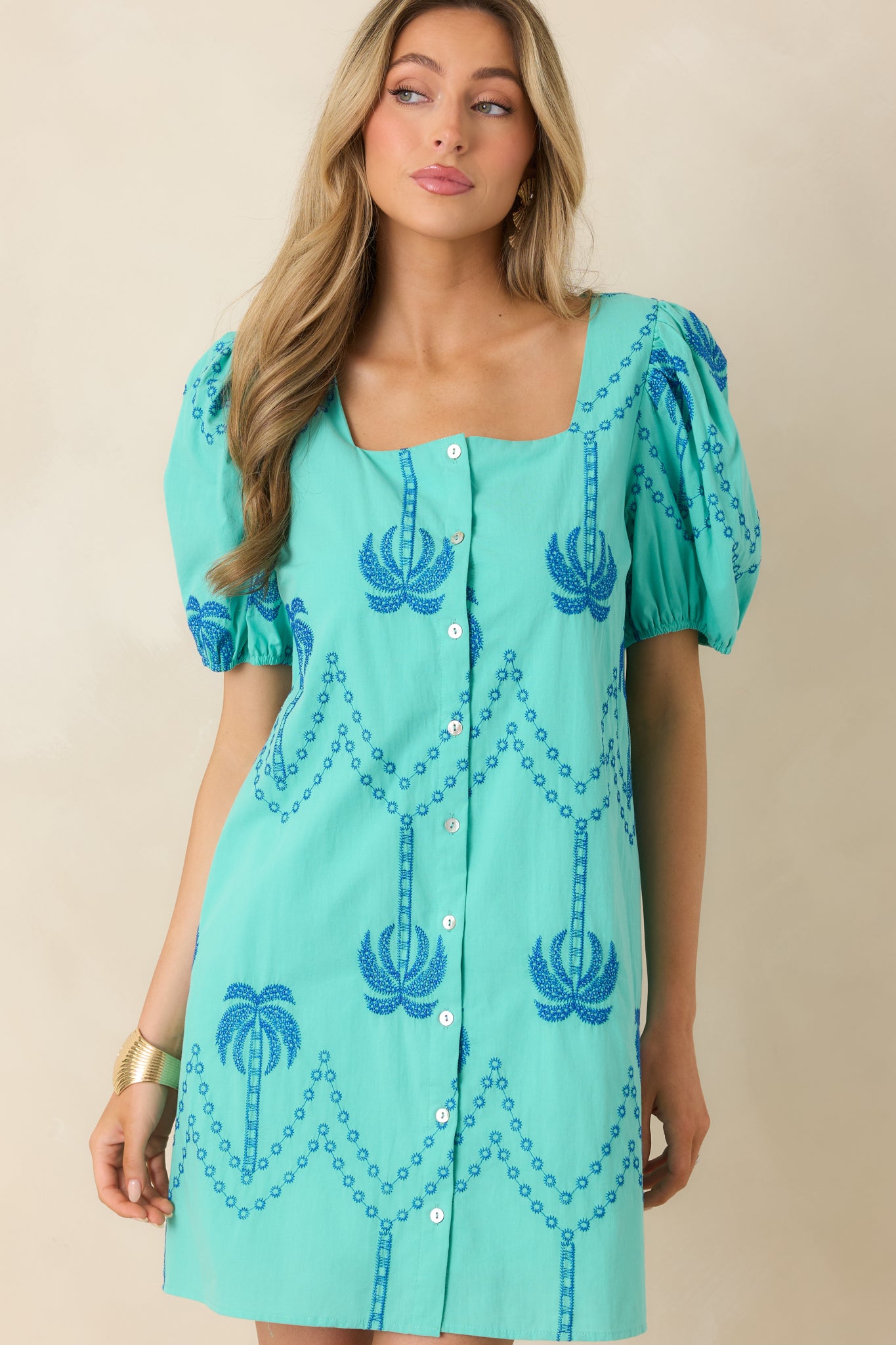 Detailed look at square neckline and functional button front on mini dress.