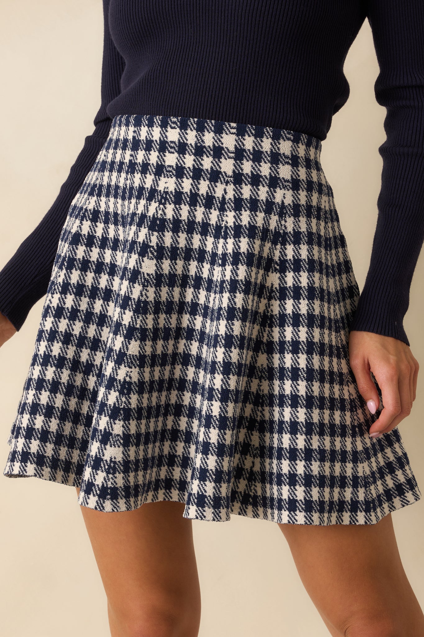 Detailed look at the navy gingham knit texture and soft stretch fabric.