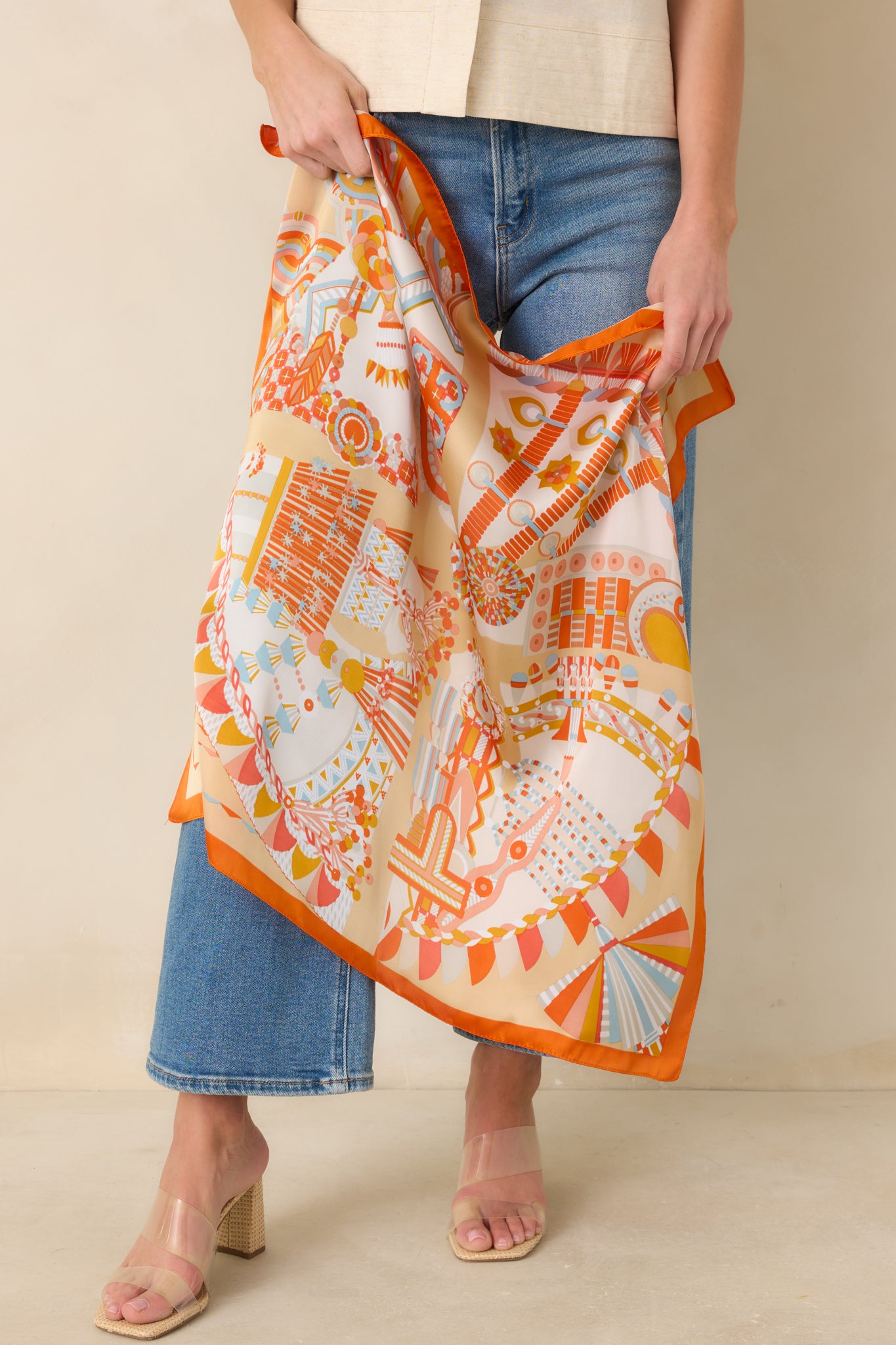 Detailed look at silky scarf surface with allover geometric print.