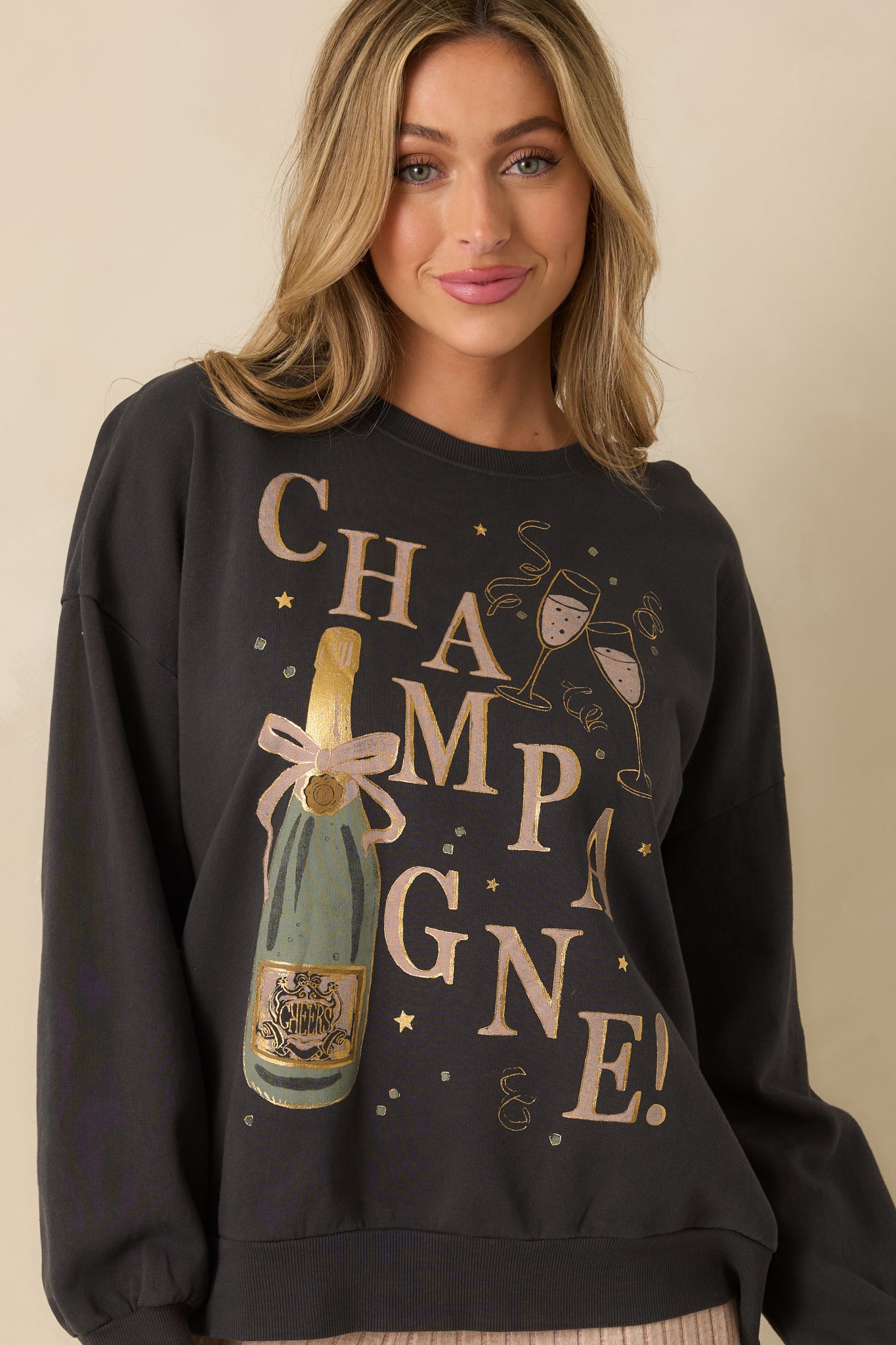 Detailed look at the graphic print across the chest and smooth black knit.