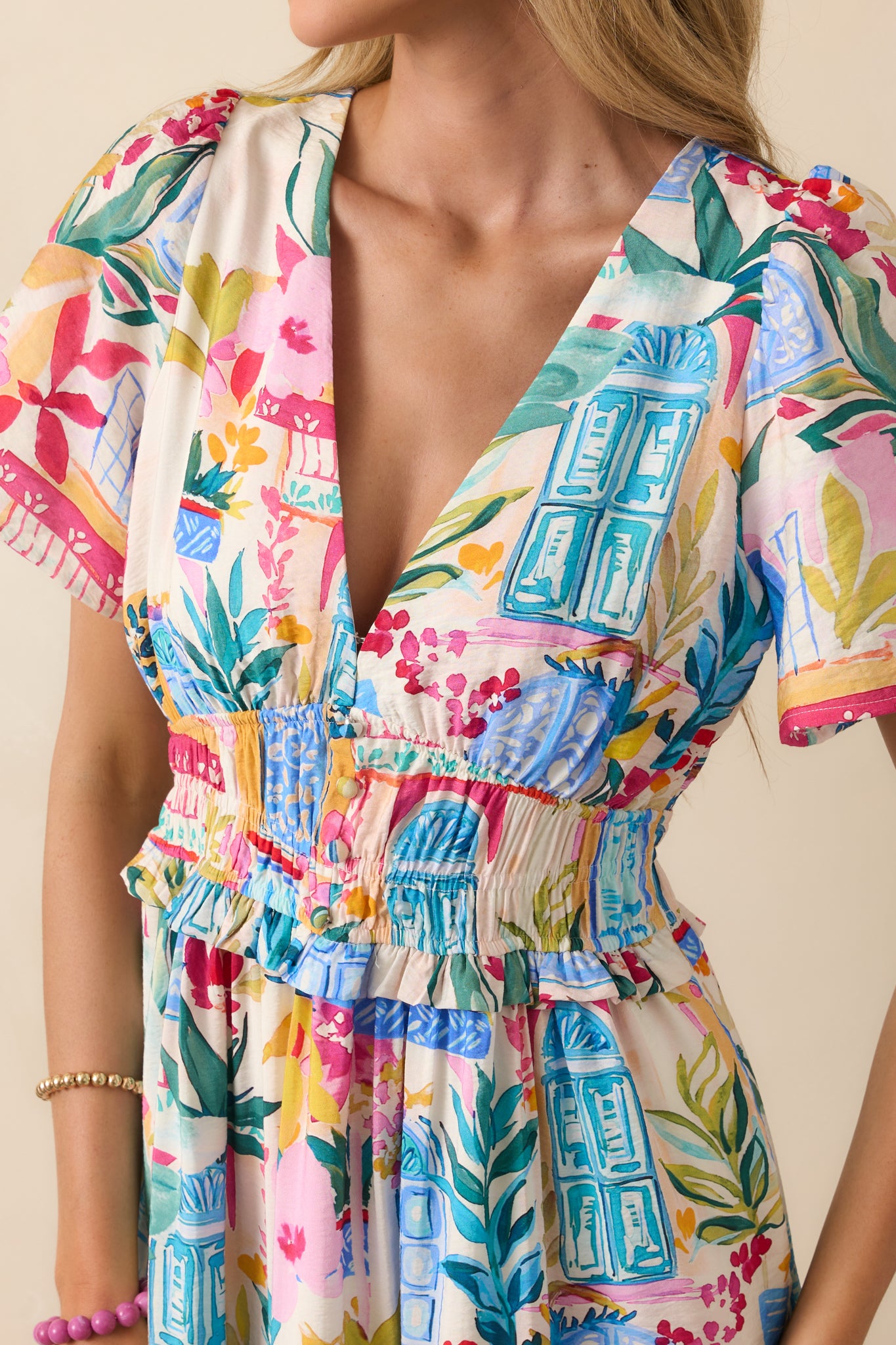 Detailed shot of the smocked waist and faux button front, showing the gathered texture and vibrancy of the watercolor print.