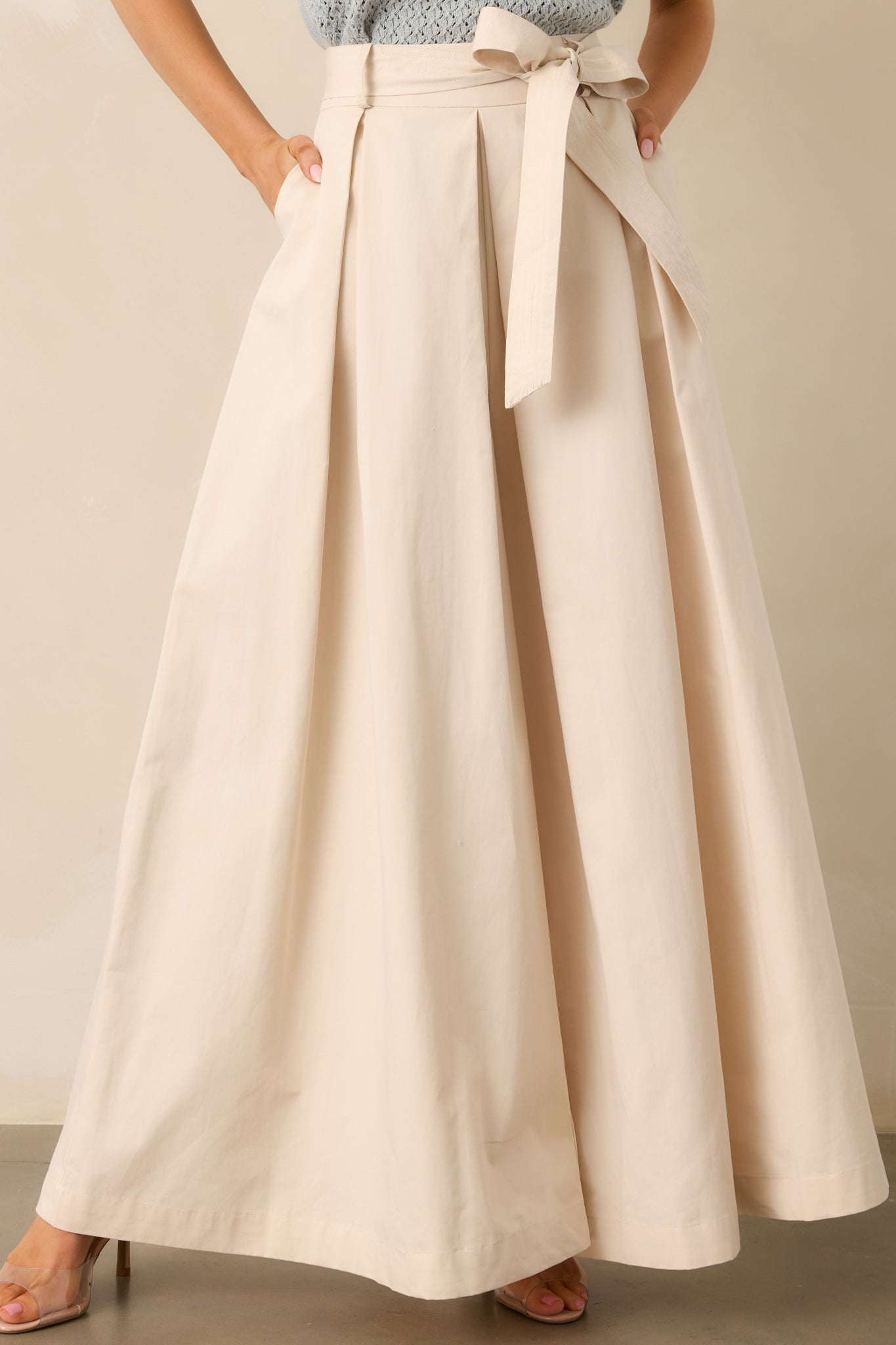 A detailed, elegant shot of the fabric and stitching near the waistband, highlighting the smooth texture and tailored finish.