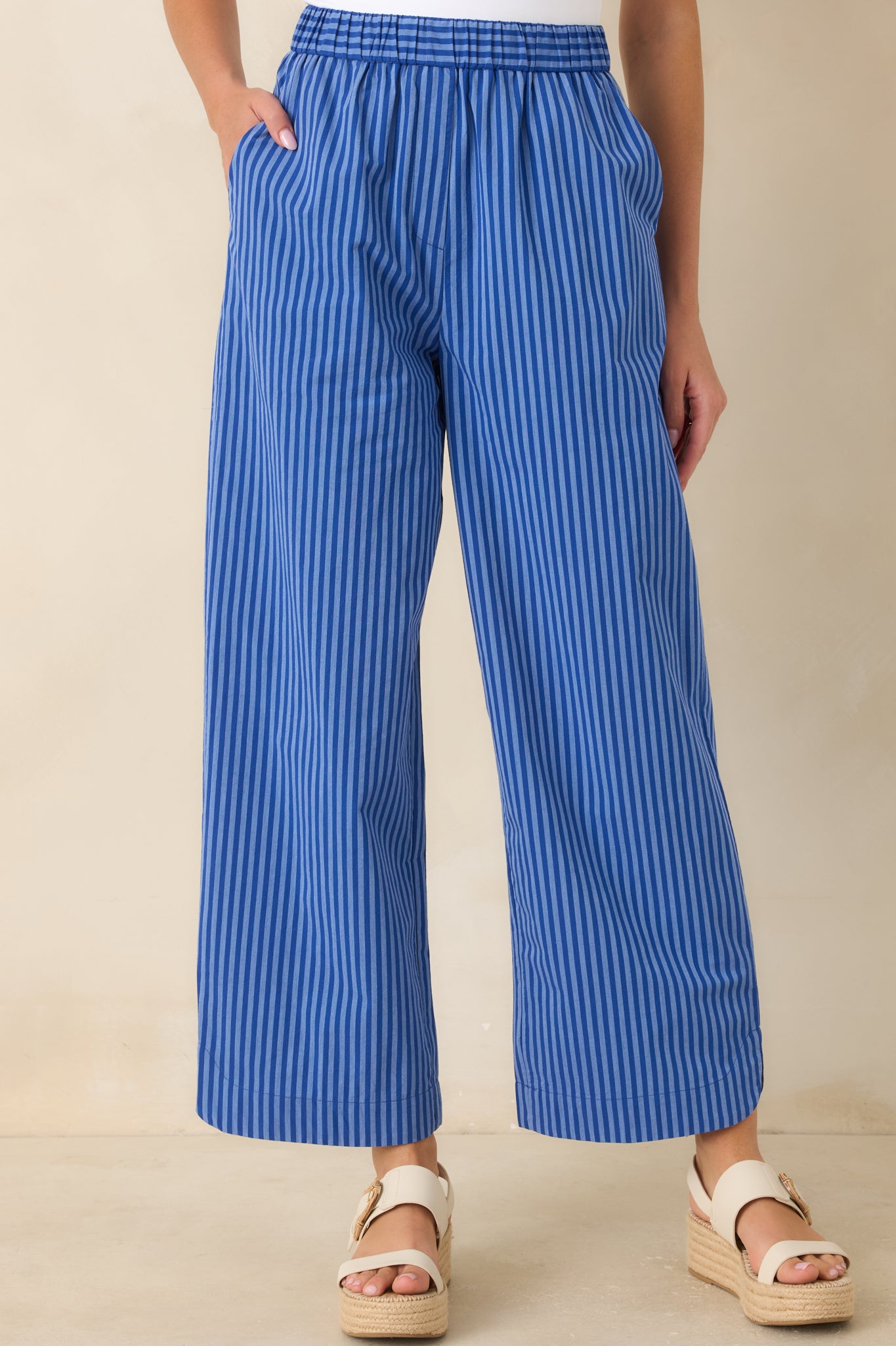 Detailed view of the electric blue vertical stripe pattern and relaxed wide-leg shape.