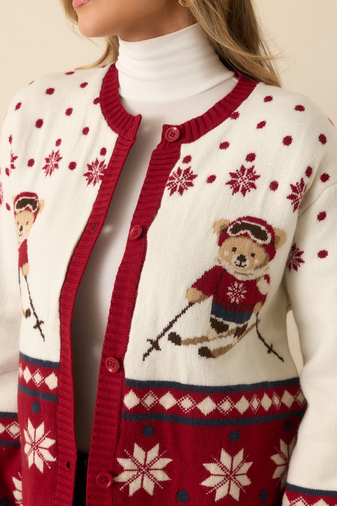 Detailed view of the intarsia knit showcasing the skiing bear, snowflakes, and textured Fair Isle elements