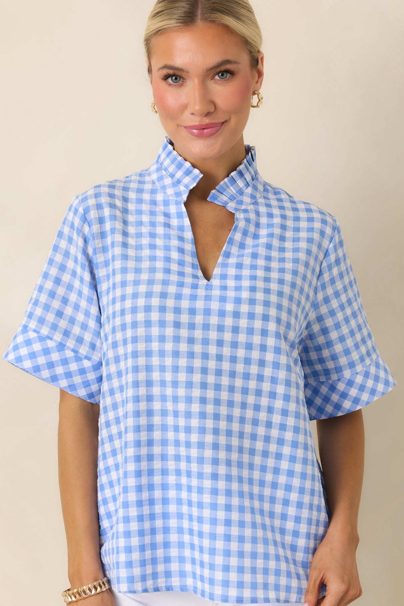 Detailed view of blue check top with collared neckline and easy structure.