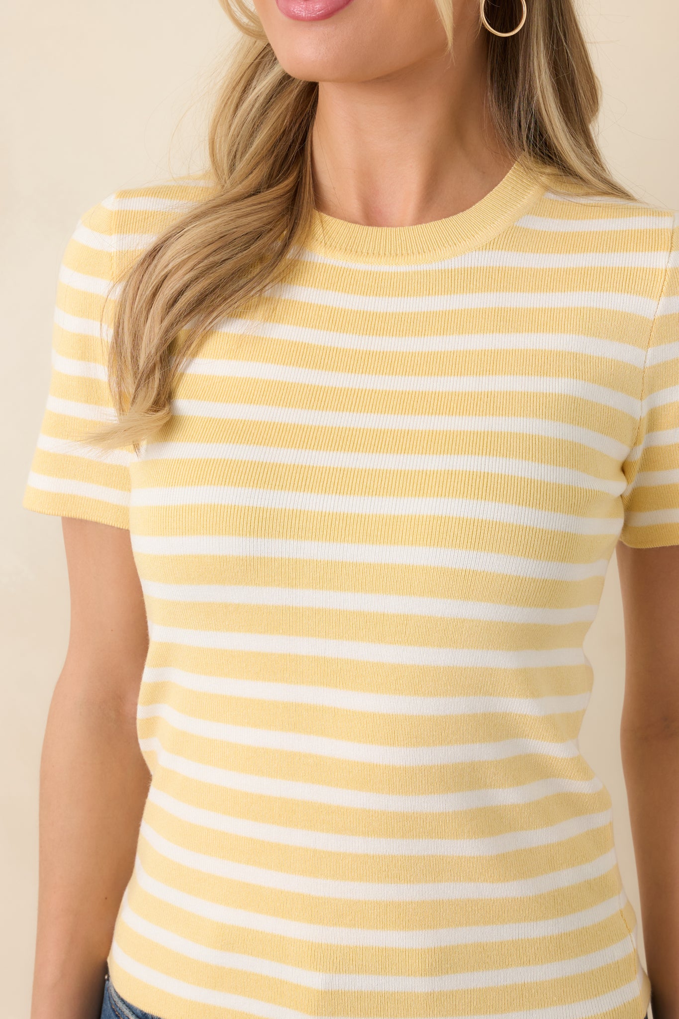 Detailed view of fabric showing soft knit texture with cheerful yellow and ivory stripes.