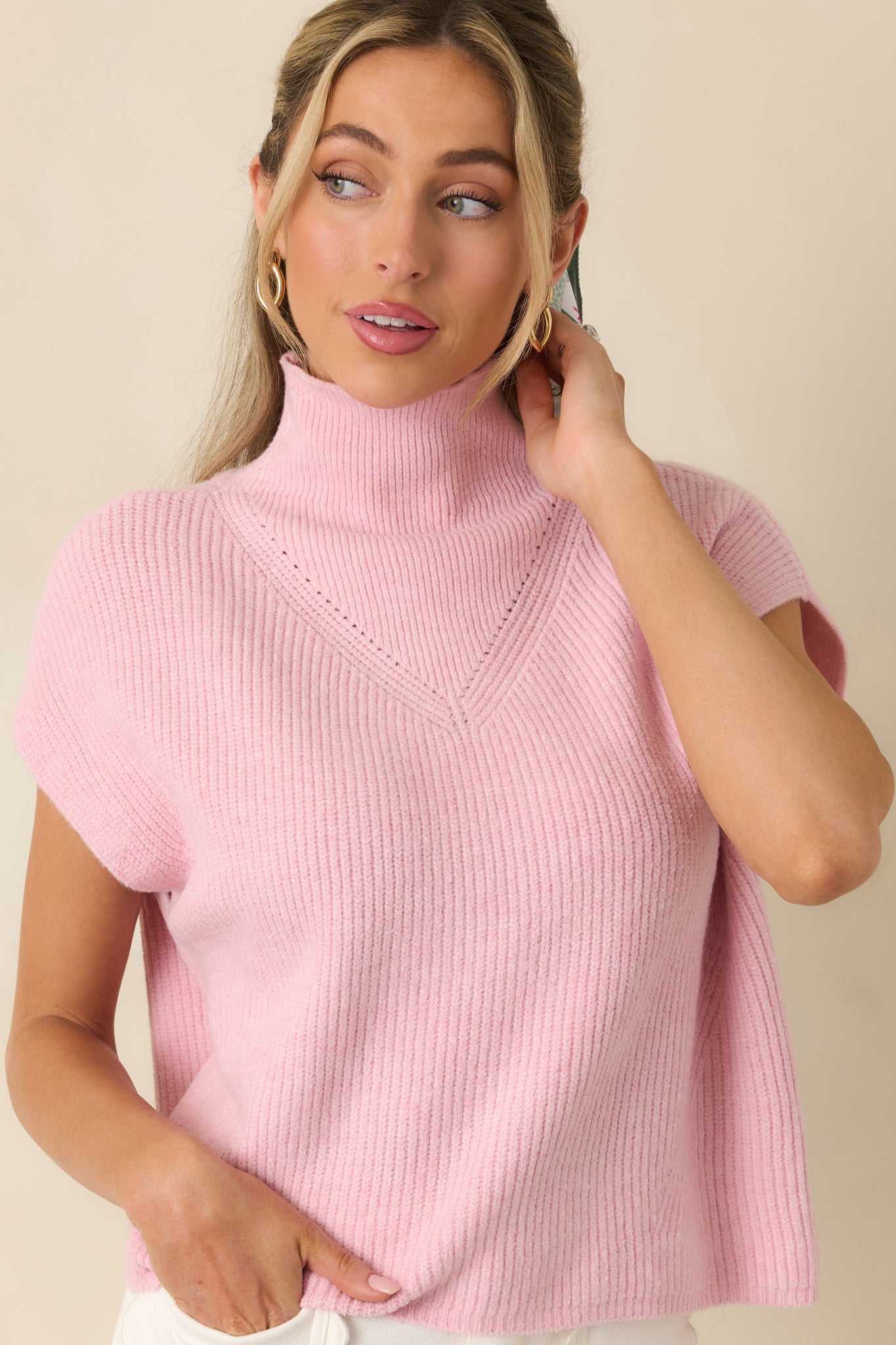 Detail-focused view of light pink cap sleeve knit edges, paired with consistent ribbed texture throughout the fabric.
