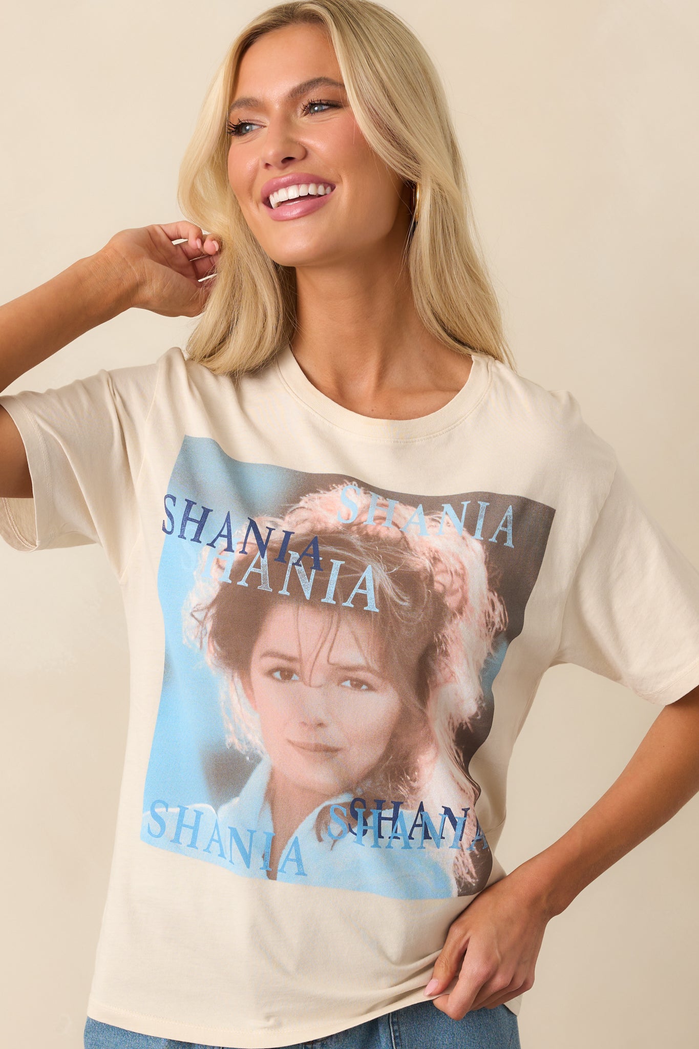 Detailed view of the ivory tee’s front, focusing on the album cover print and relaxed fit cut of the shirt.