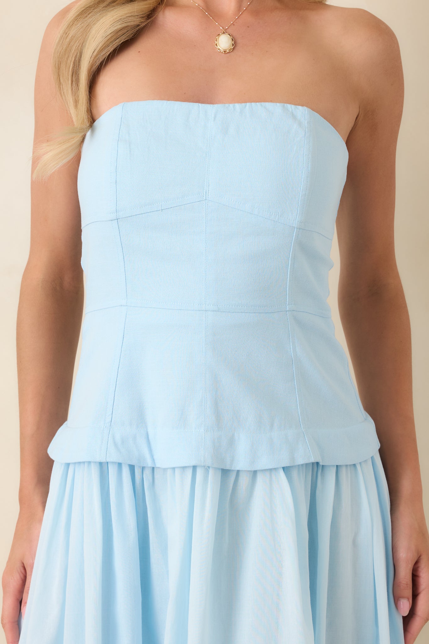 Detailed view of the bustier-style paneled bodice, highlighting the precise stitching and smooth fully lined fabric.