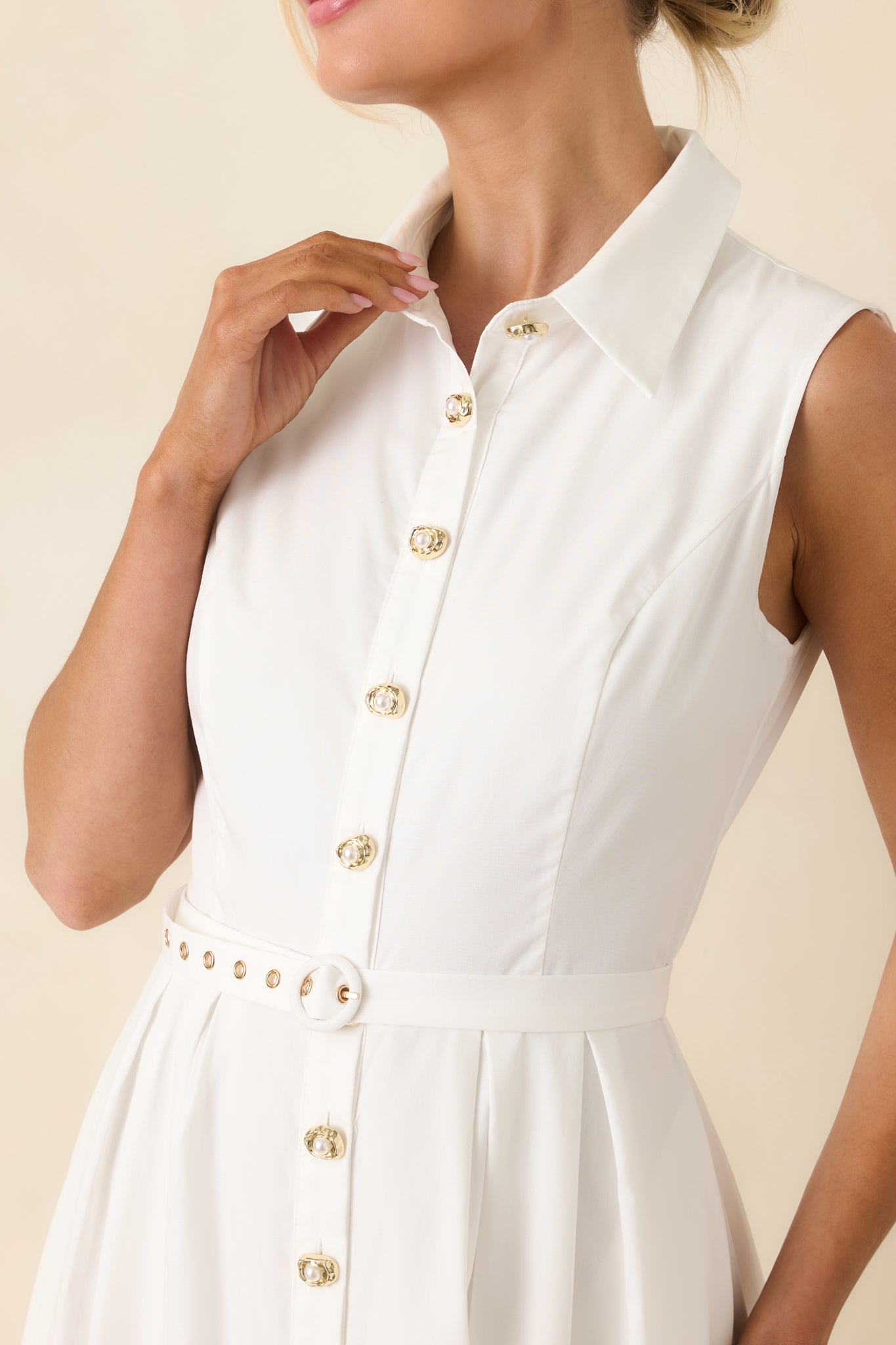 Detailed view of the gold button-front detail, structured bodice, and coordinating waist belt.