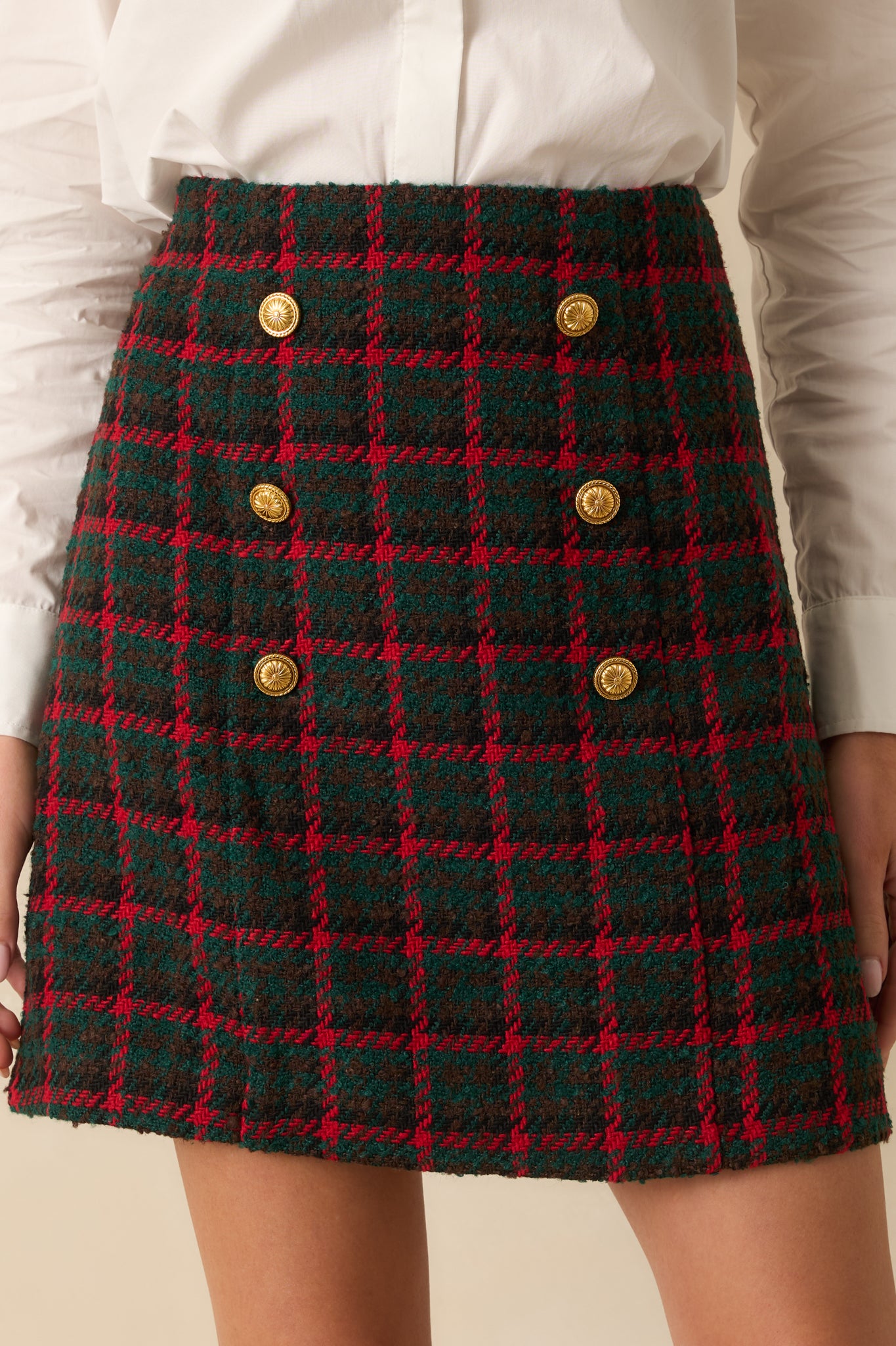 Detailed view showcasing the woven tweed texture and the shine of the gold button accents.