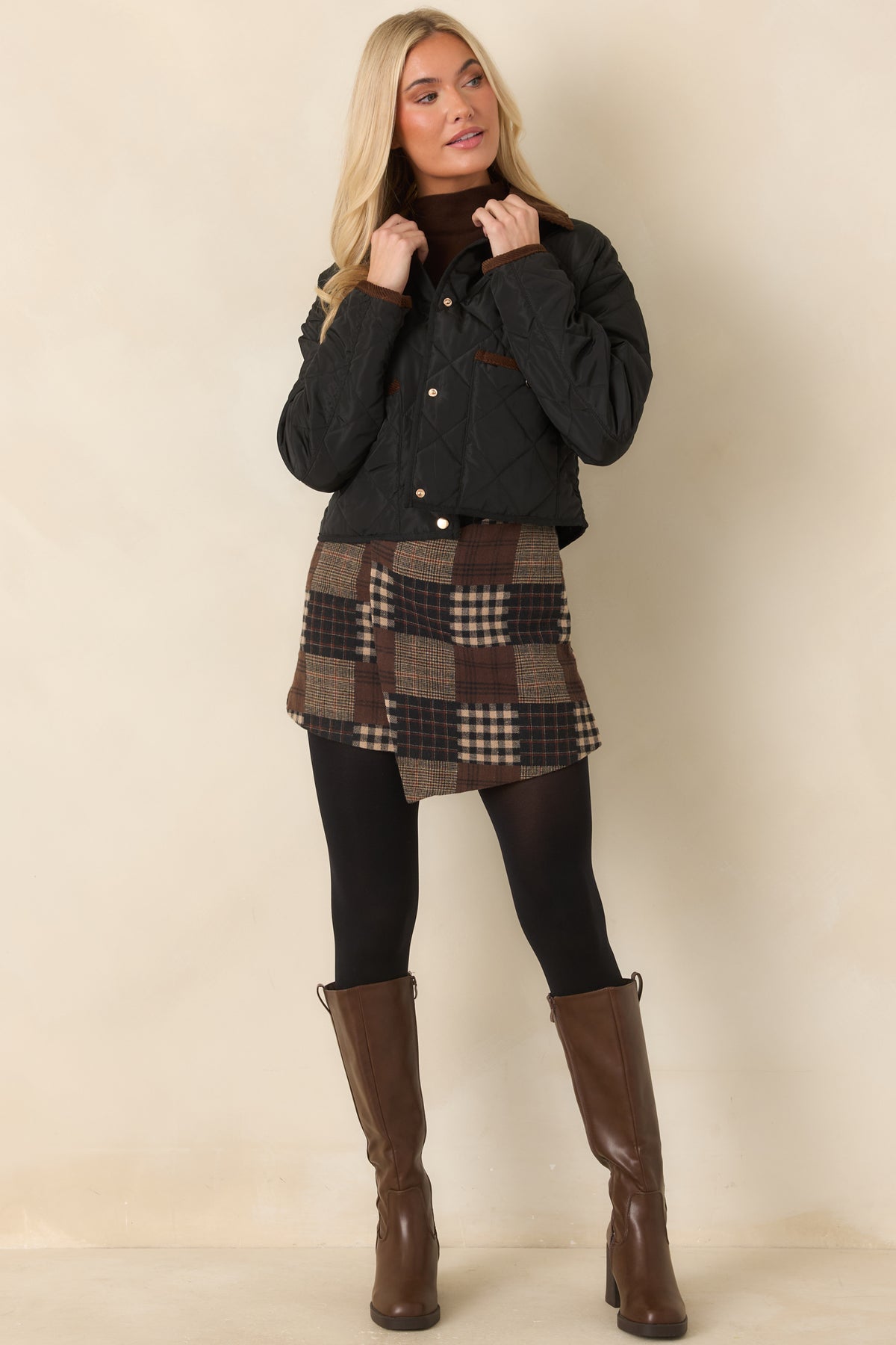 Diamond-quilted jacket with a contrasting brown collar, snap-front closure, and contrast-trimmed patch pockets.