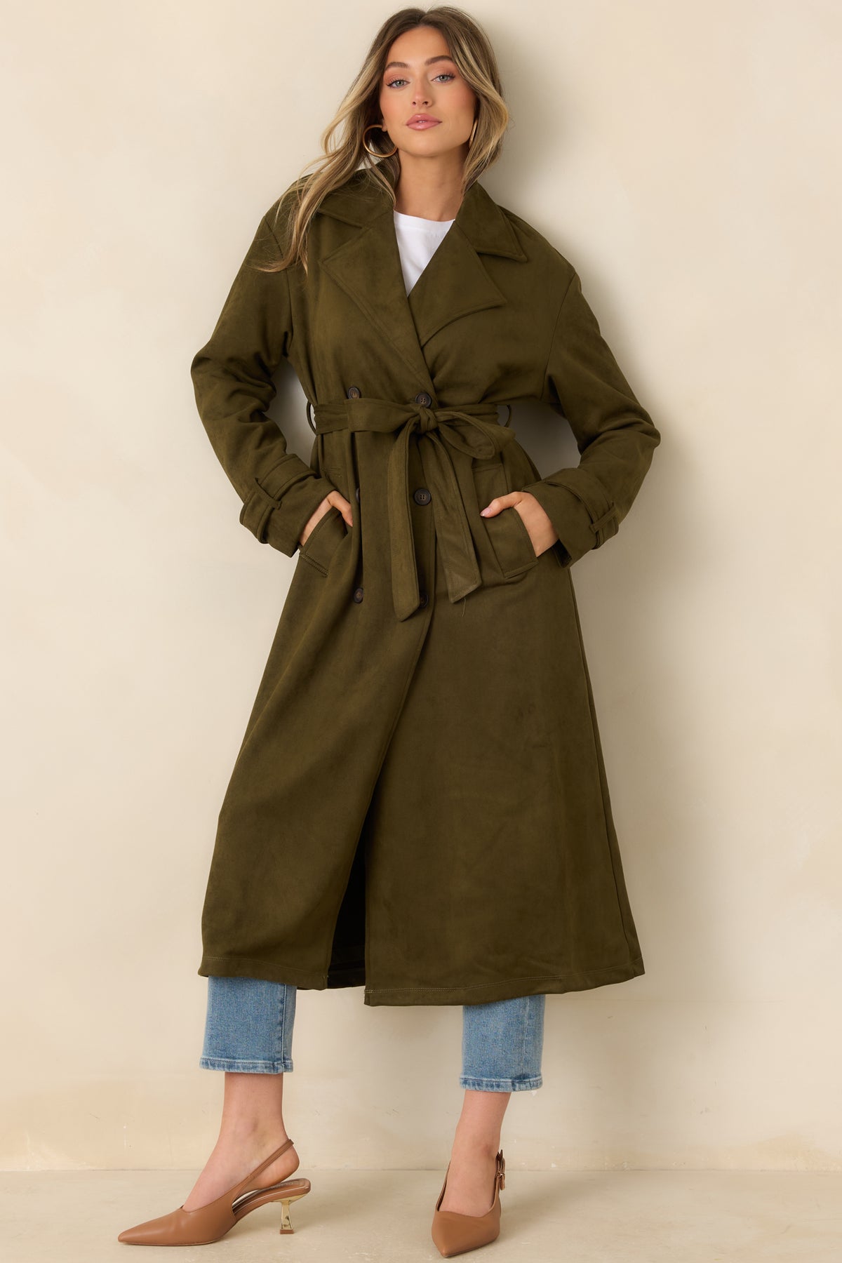Double-breasted coat with a fitted waist, long sleeves, and a coordinating fabric belt.