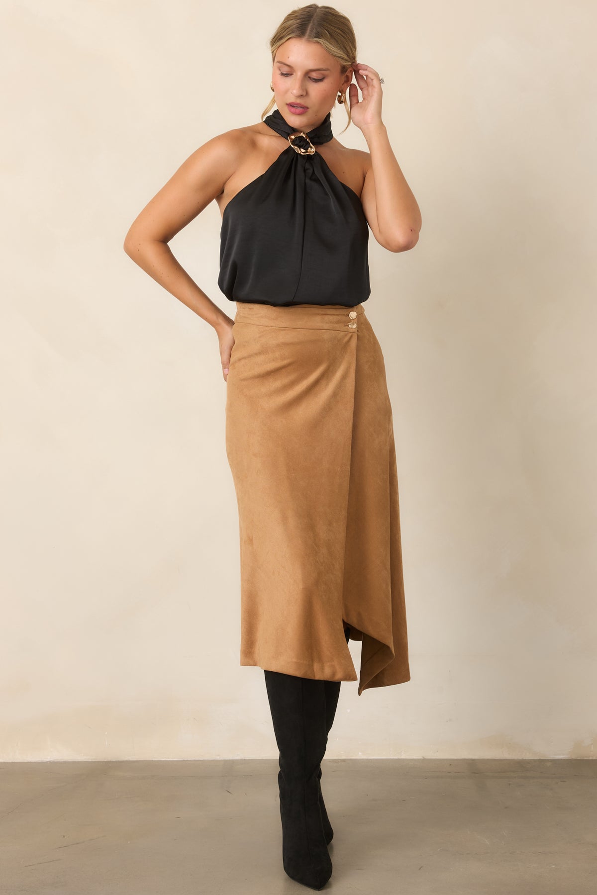 Draped halter top featuring a gathered front and decorative ring detail.
