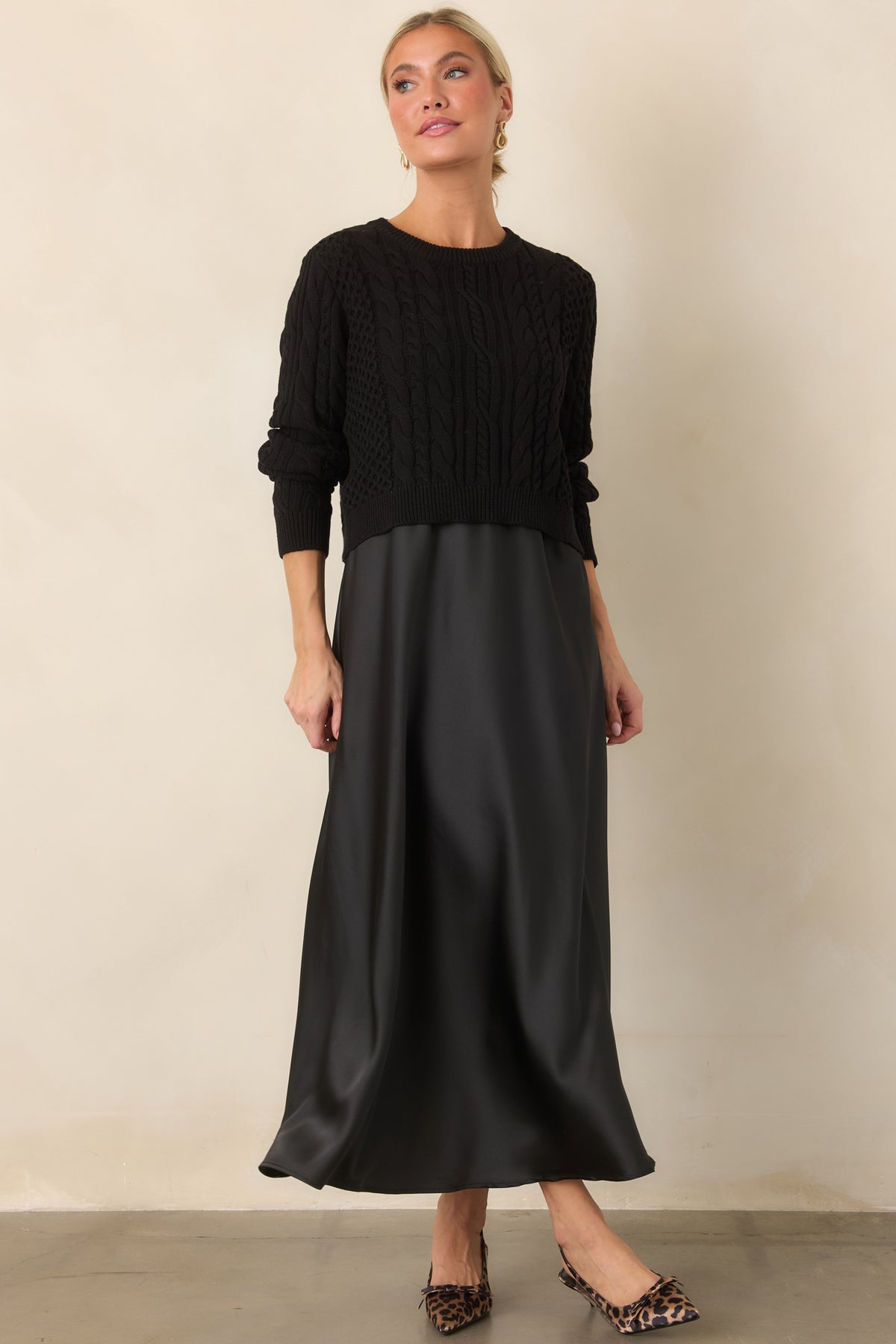 Draped satin maxi dress creates an elegant elongated silhouette with the intricate knit layer adding texture.