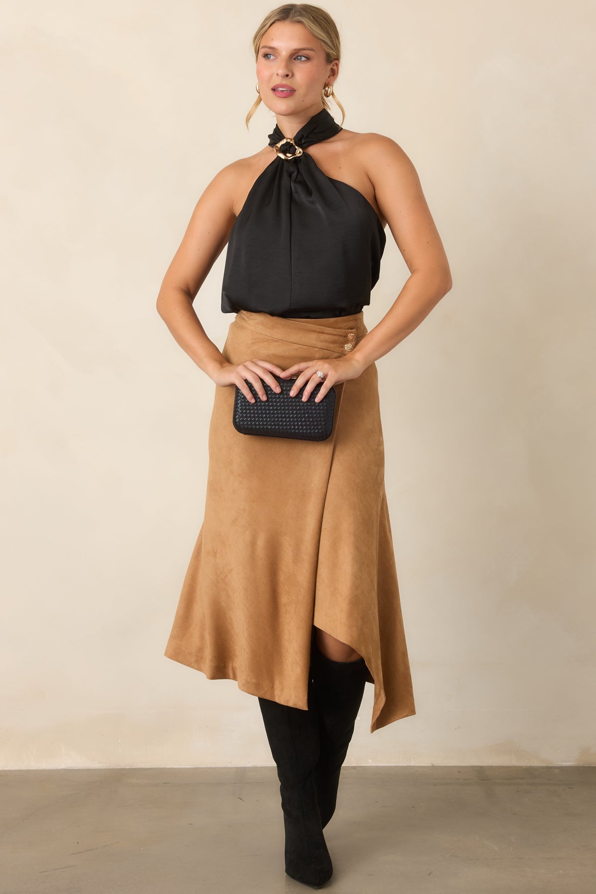 Draped sleeveless top featuring a halter neckline and decorative ring accent.