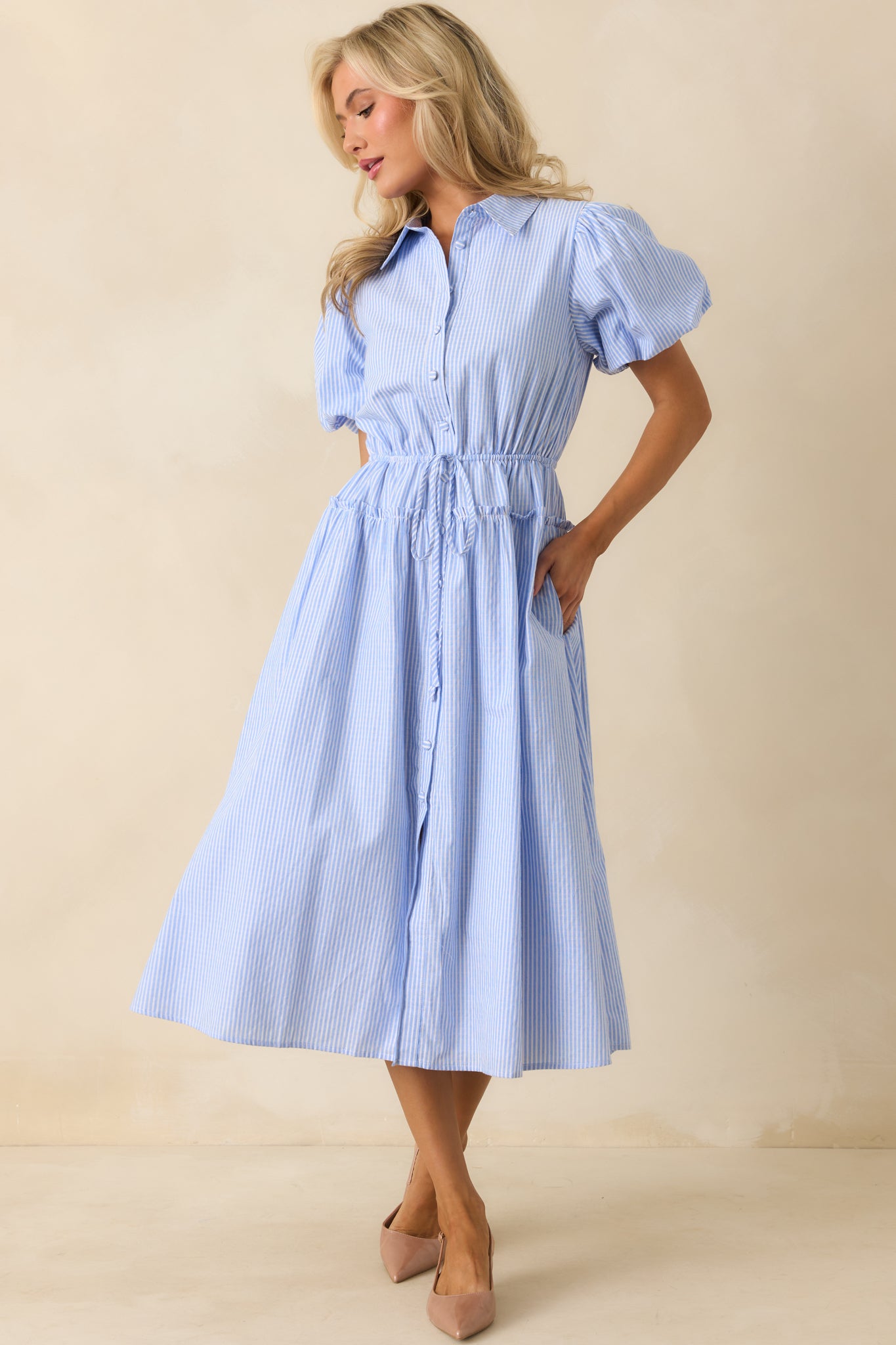 Dress shown with the collar buttoned up, emphasizing the structured neckline and vertical stripes.