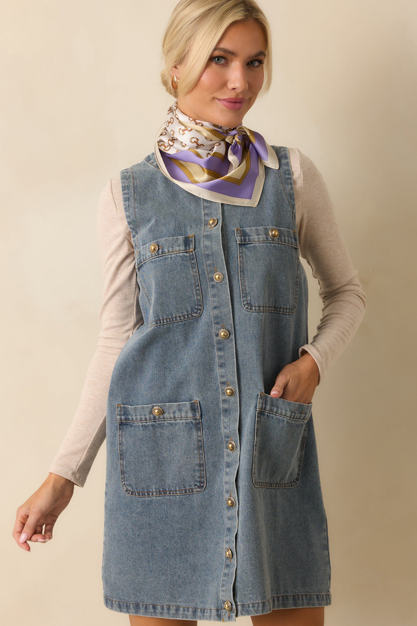 A cropped view showing the upper portion of the dress with functional pockets and a sleeveless design.
