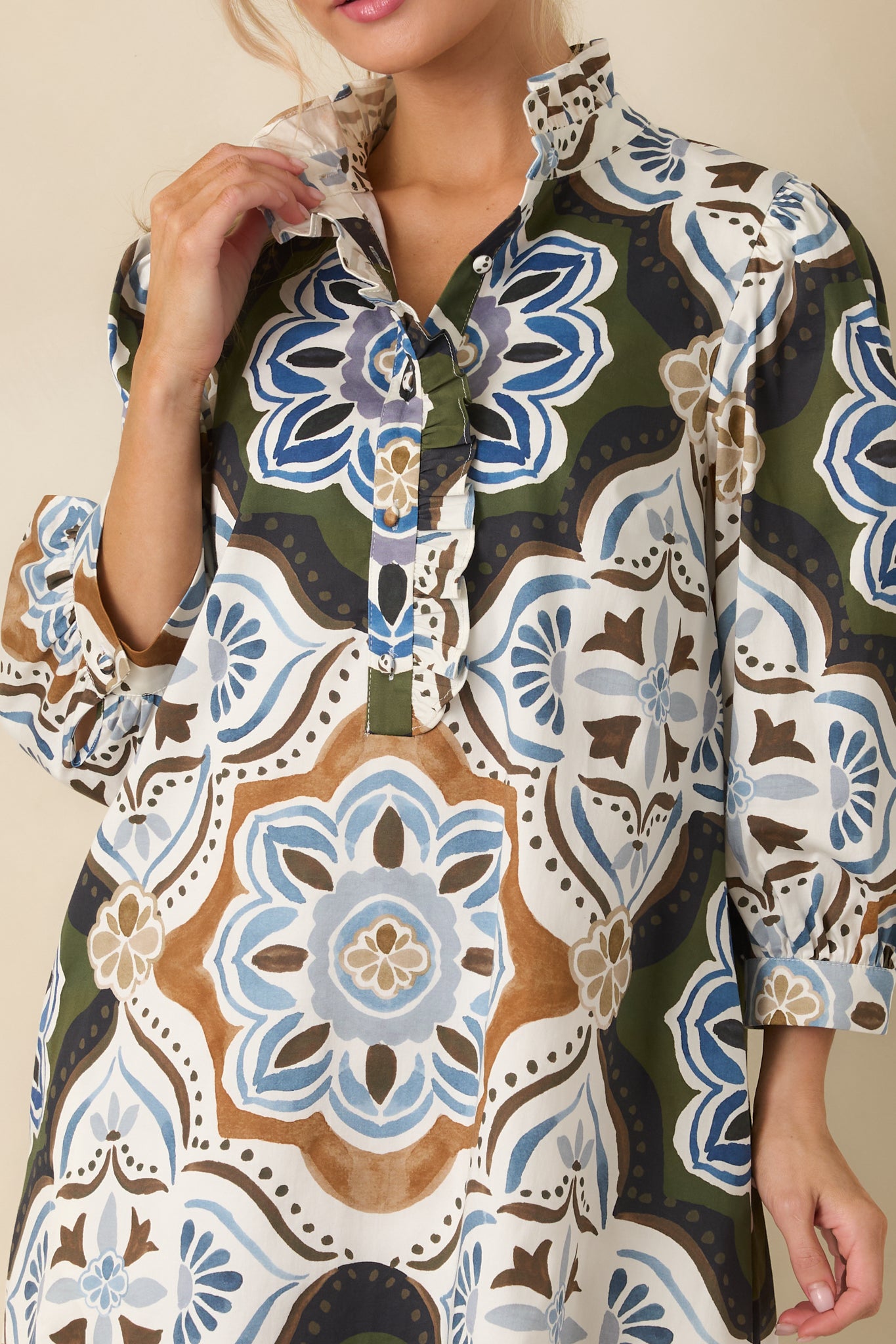 Close-up detail of the dress showing the ornate multicolor medallion print against an olive green background.