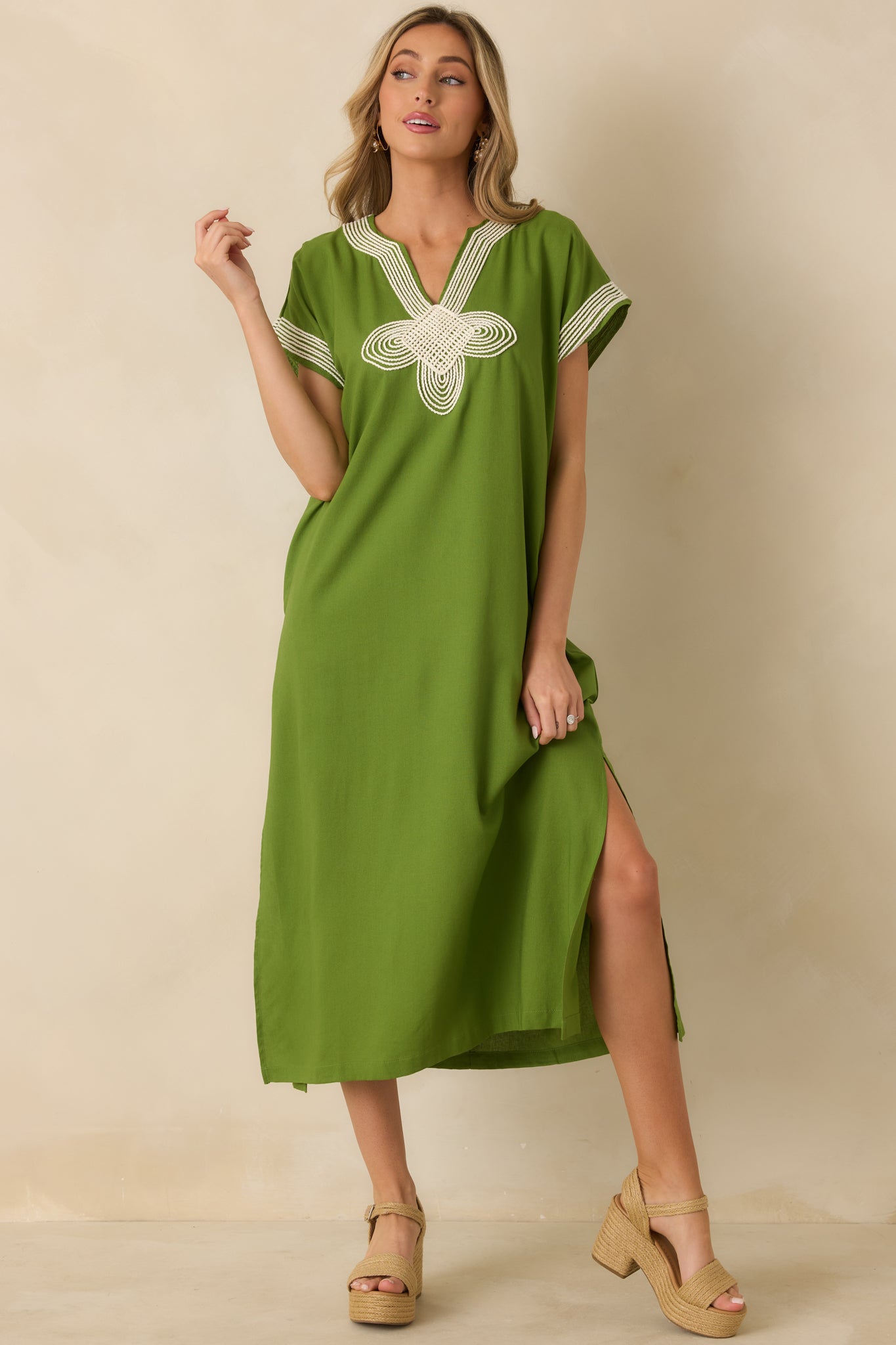 Green maxi dress with a split V-neckline, cap sleeves, and a relaxed straight silhouette.