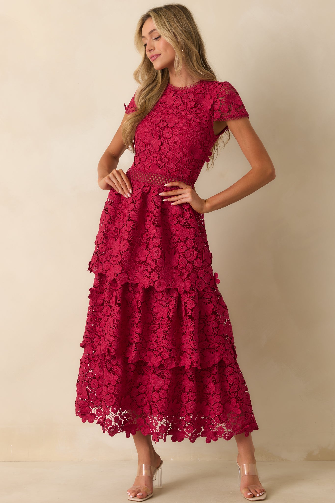 Dress styled with a tiered skirt and scalloped hem accents.