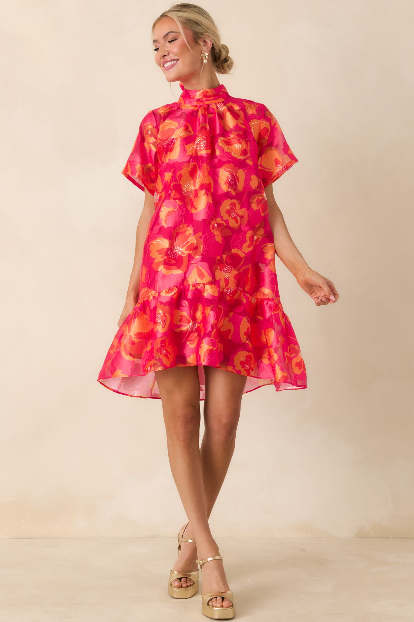 Dress with high neckline, tiered ruffle hem, and soft gathered detailing for a relaxed fit.