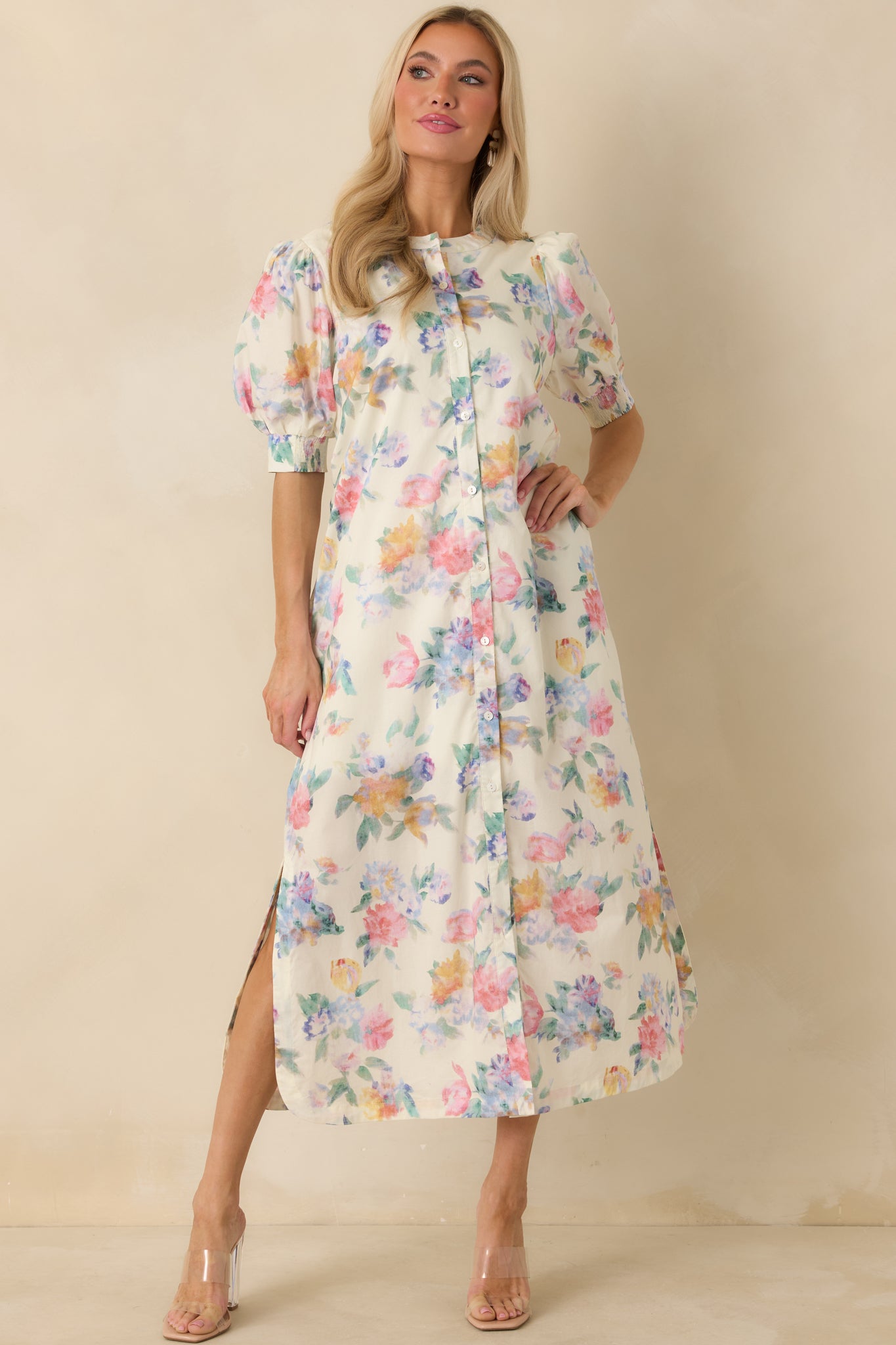 White floral maxi dress with puff sleeves, round neckline, and lightweight cotton fabric, showcasing a full-length hem.