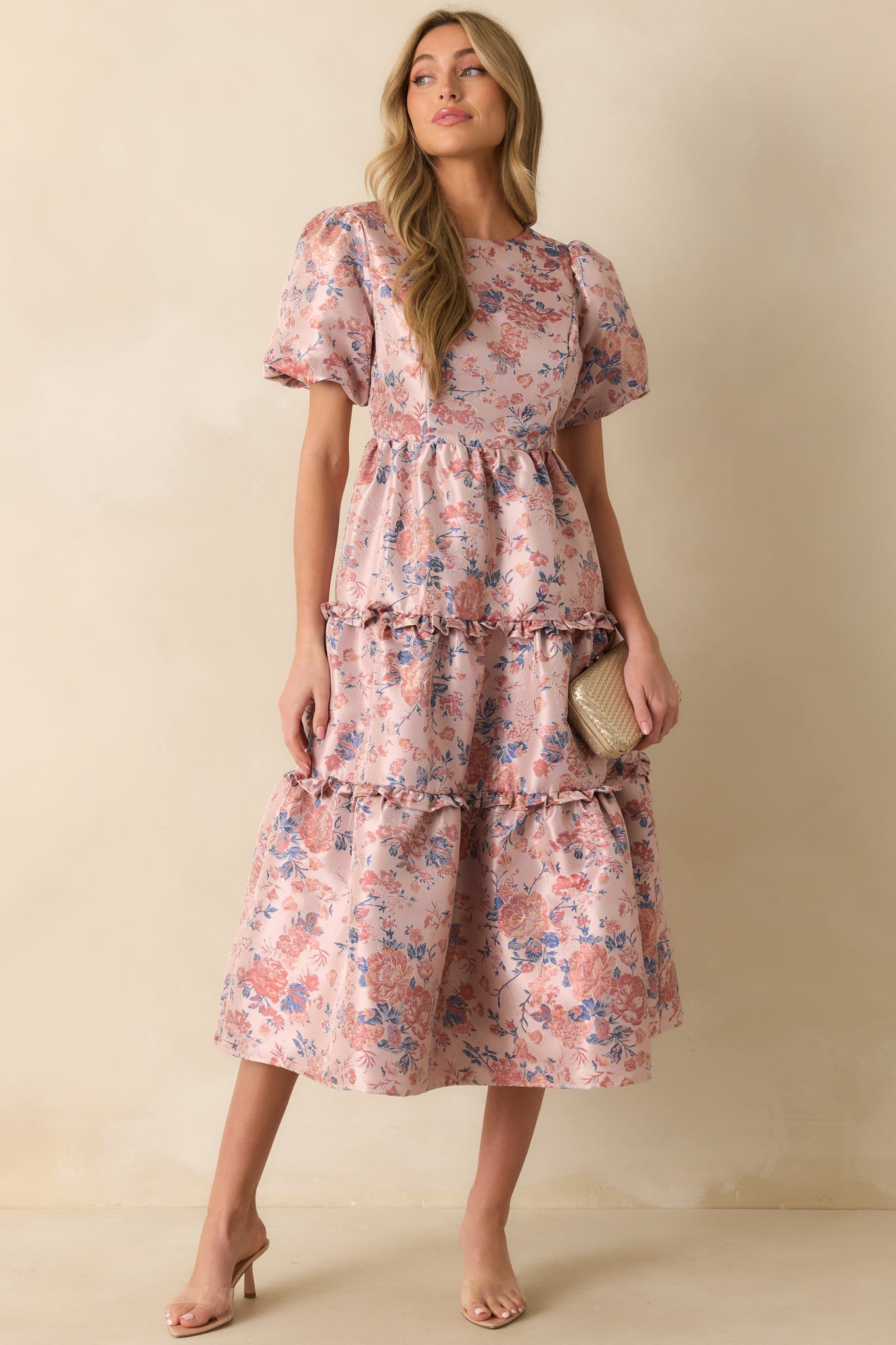 Dress featuring tiered skirt with ruffle detailing and slightly flared silhouette.