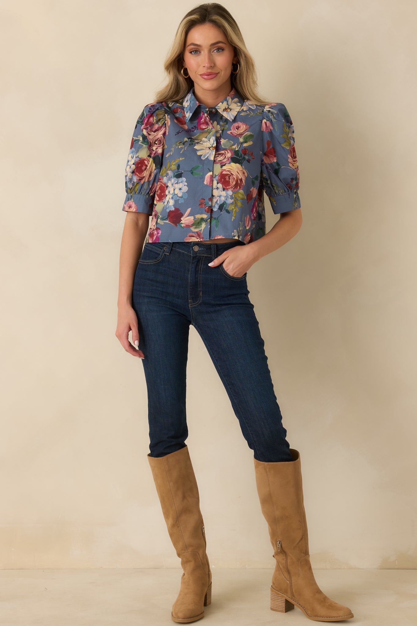 Dusty blue cotton blouse featuring painterly floral blooms, a pointed collar, puff sleeves, and wide cuffs.