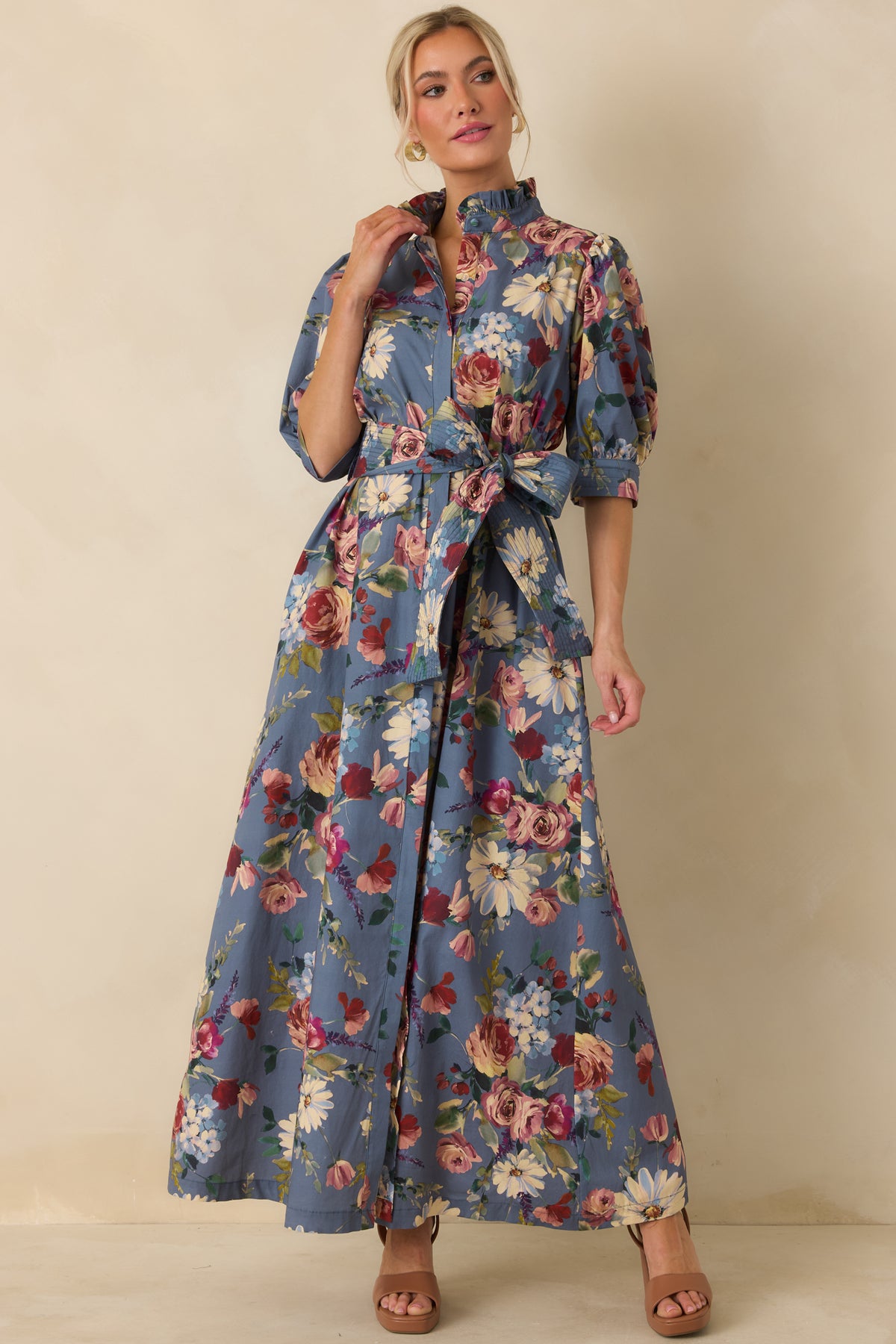Dusty blue cotton maxi dress with garden-inspired florals, elbow-length puff sleeves, and convenient side pockets.