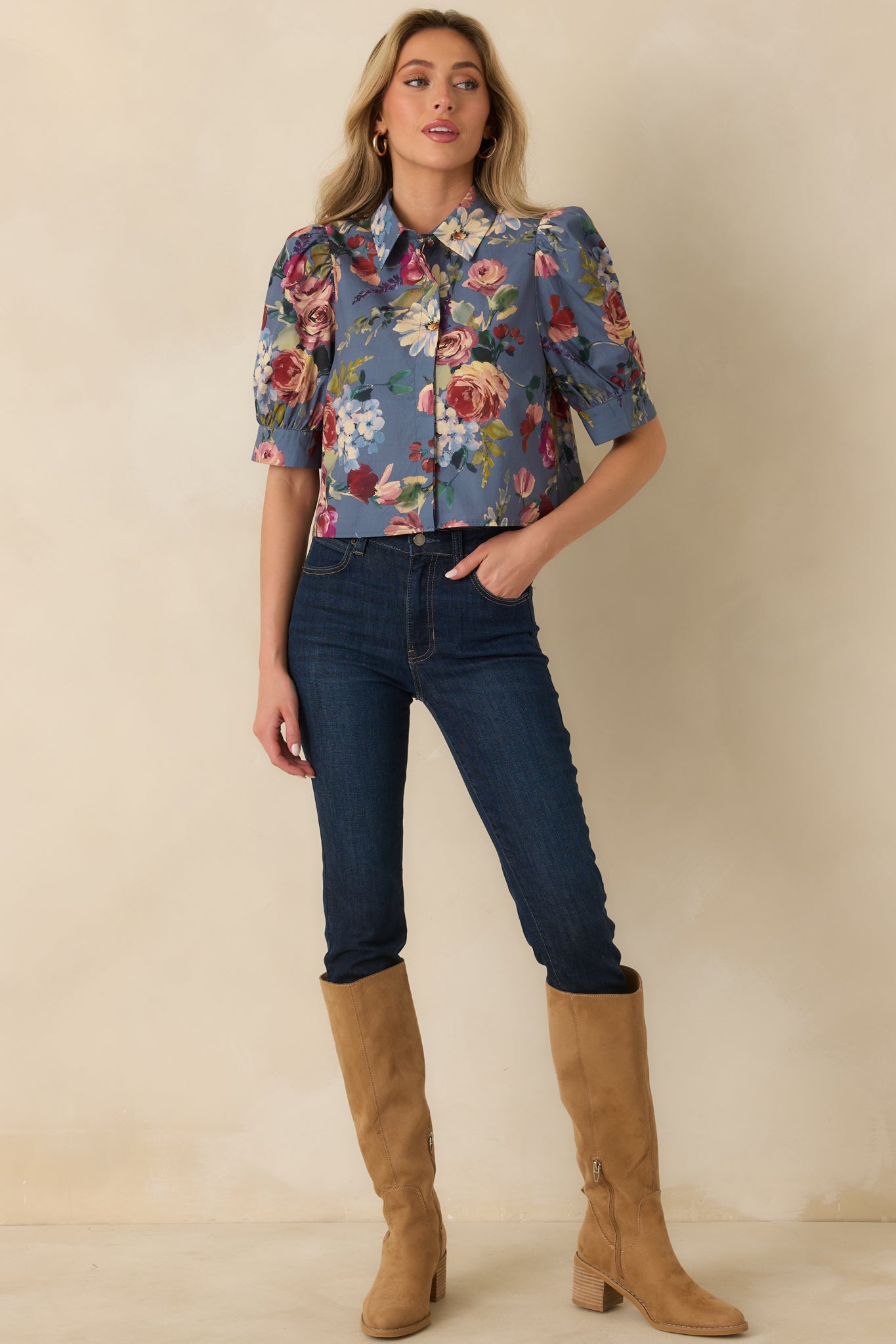 Dusty blue floral blouse showcasing blush, burgundy, ivory, and green blooms across the cotton fabric.