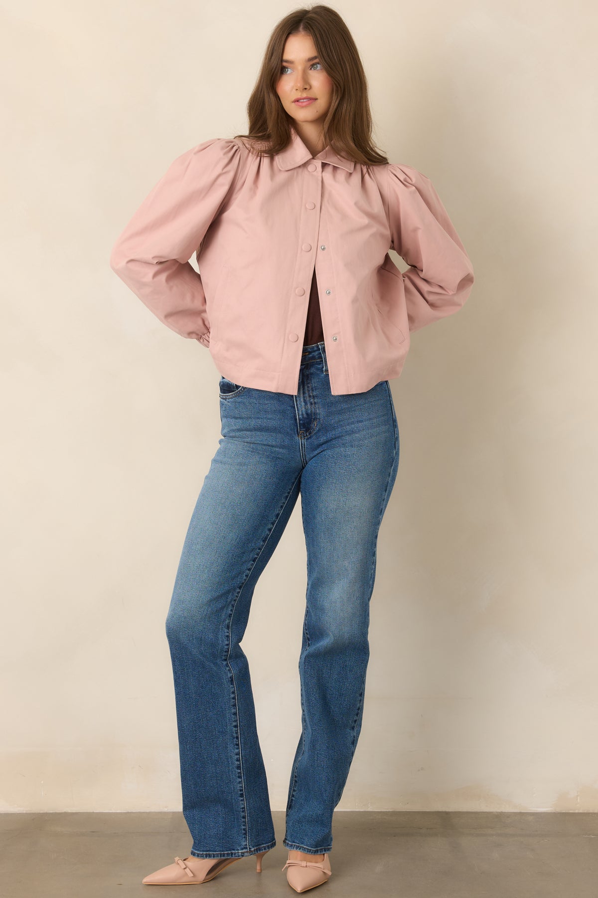 Dusty pink cropped jacket featuring a pointed collar, snap front closure, gathered shoulders, voluminous puff sleeves, and elasticized cuffs.