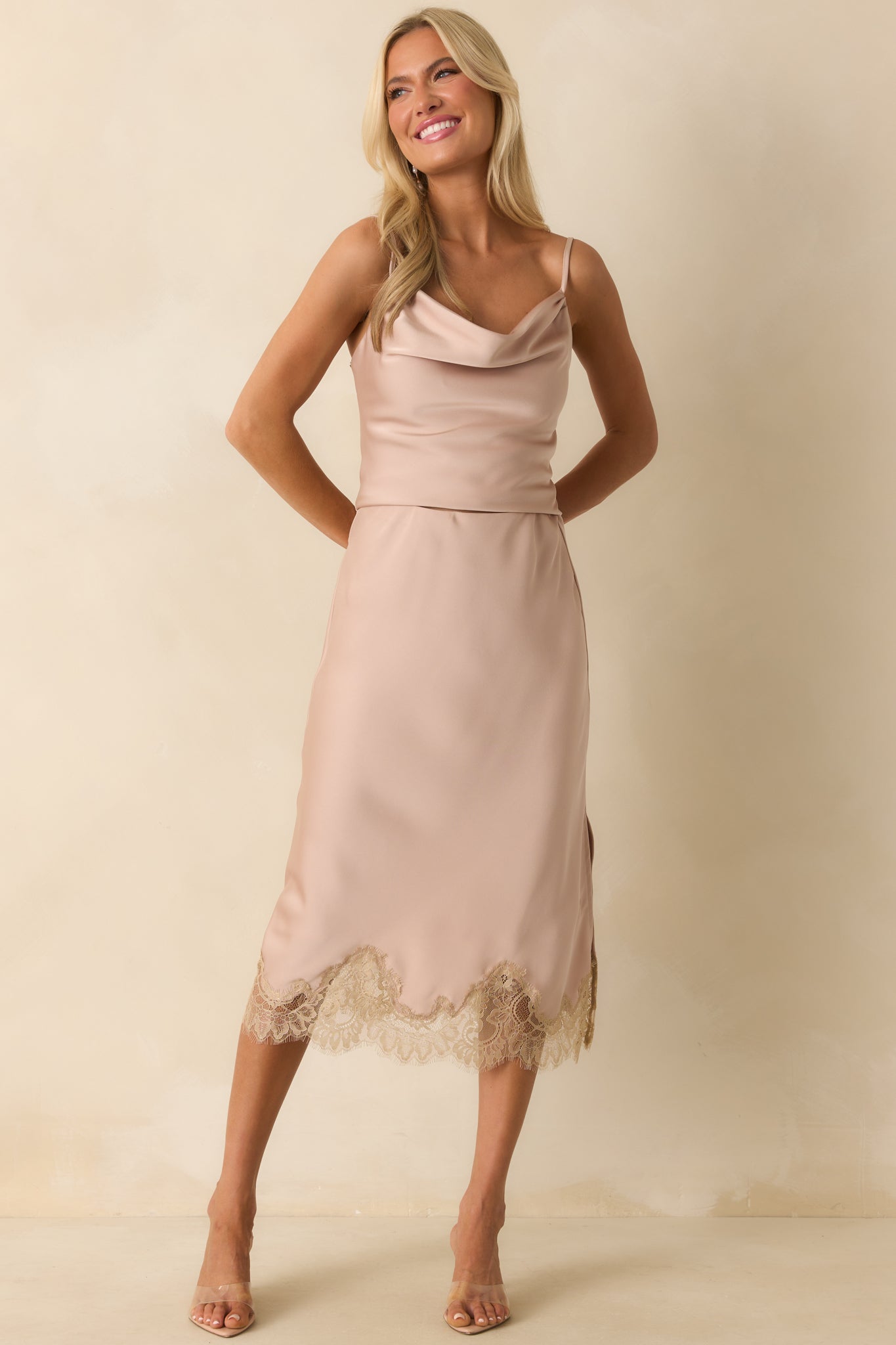 Dusty pink midi skirt with sleek satin finish, high-rise elastic waistband, and straight silhouette.
