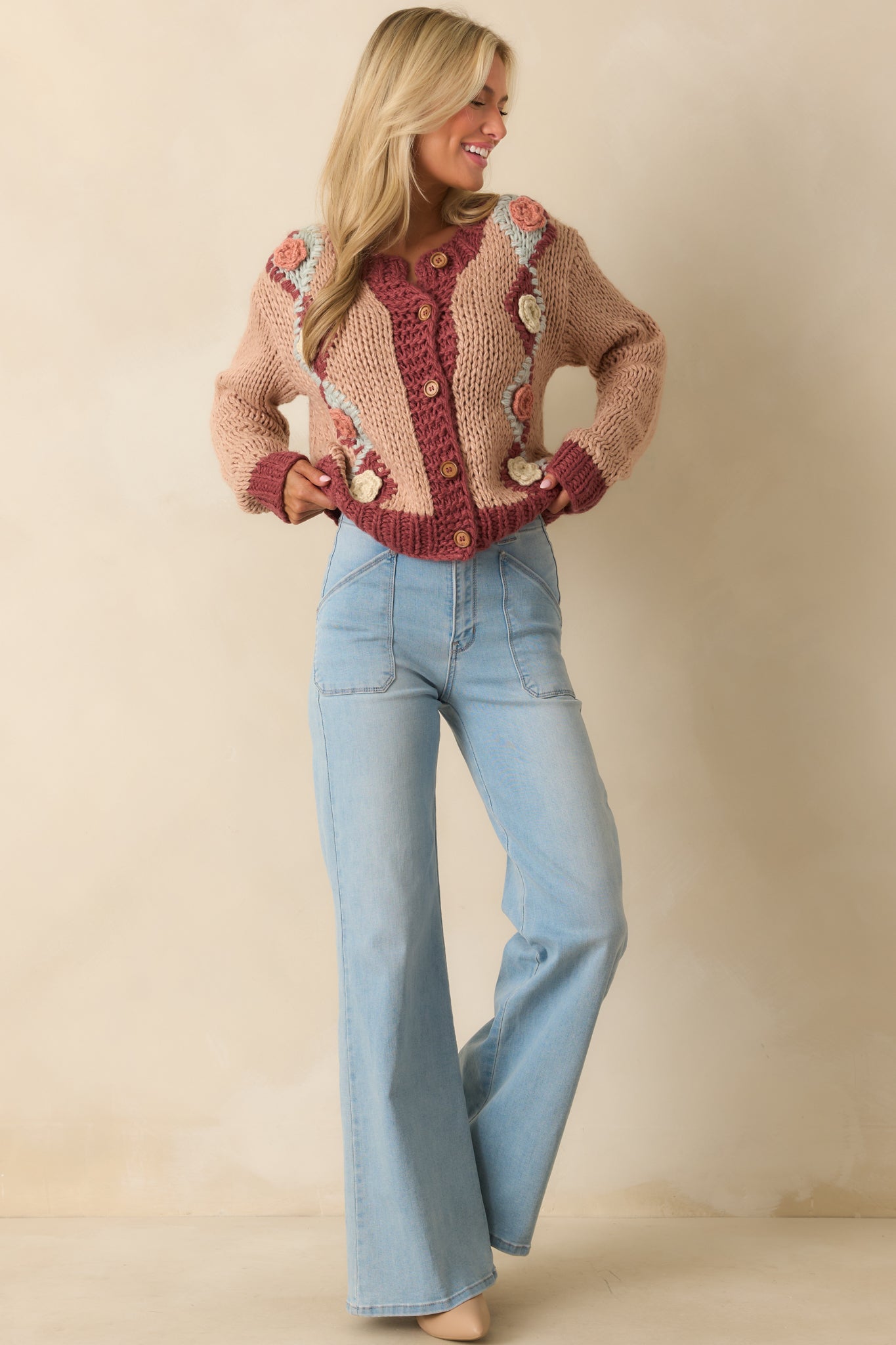 Dusty rose pink cardigan with multicolor floral details and casual oversized silhouette.