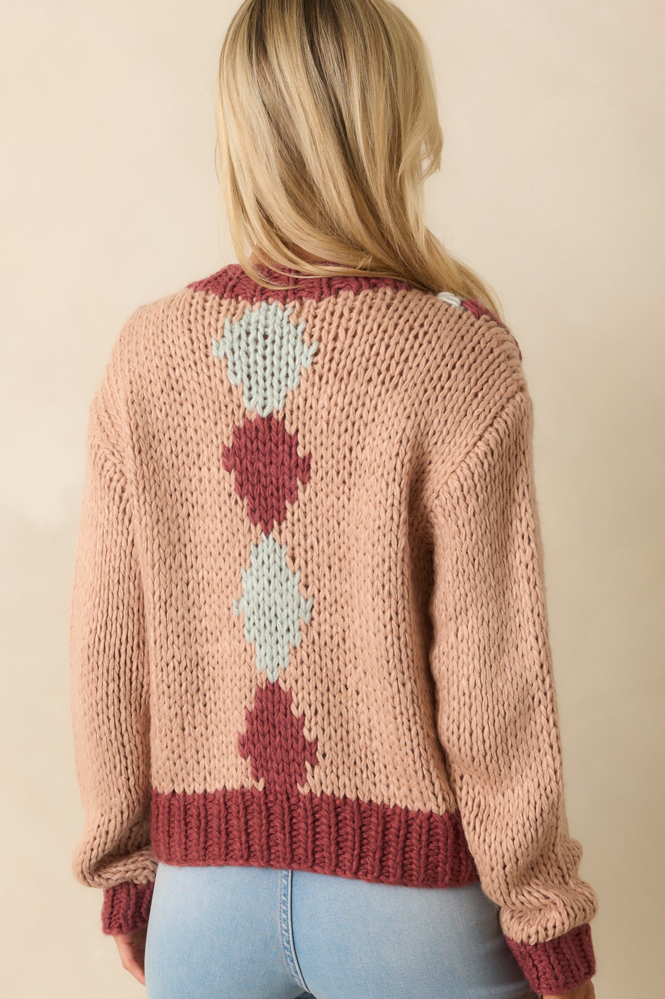 Dusty rose cardigan from the rear showing relaxed fit and contrast ribbed trim along the hem and cuffs.