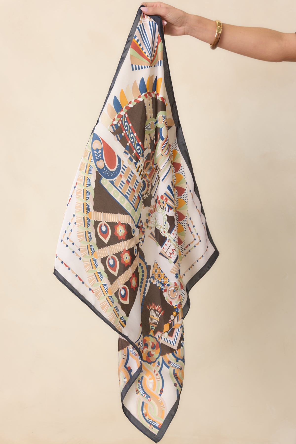 Statement scarf with intricate decorative borders, warm earthy tones, and contrasting charcoal edging.