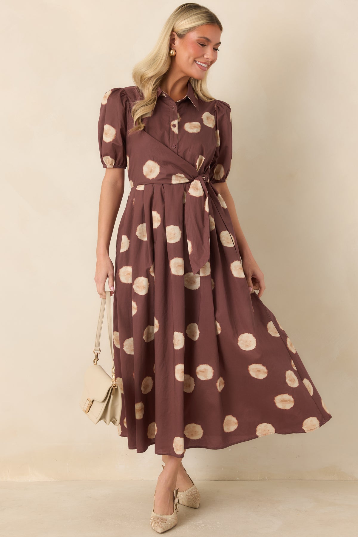 Earthy printed dress with a collared neckline, button-front bodice, and defined waist.