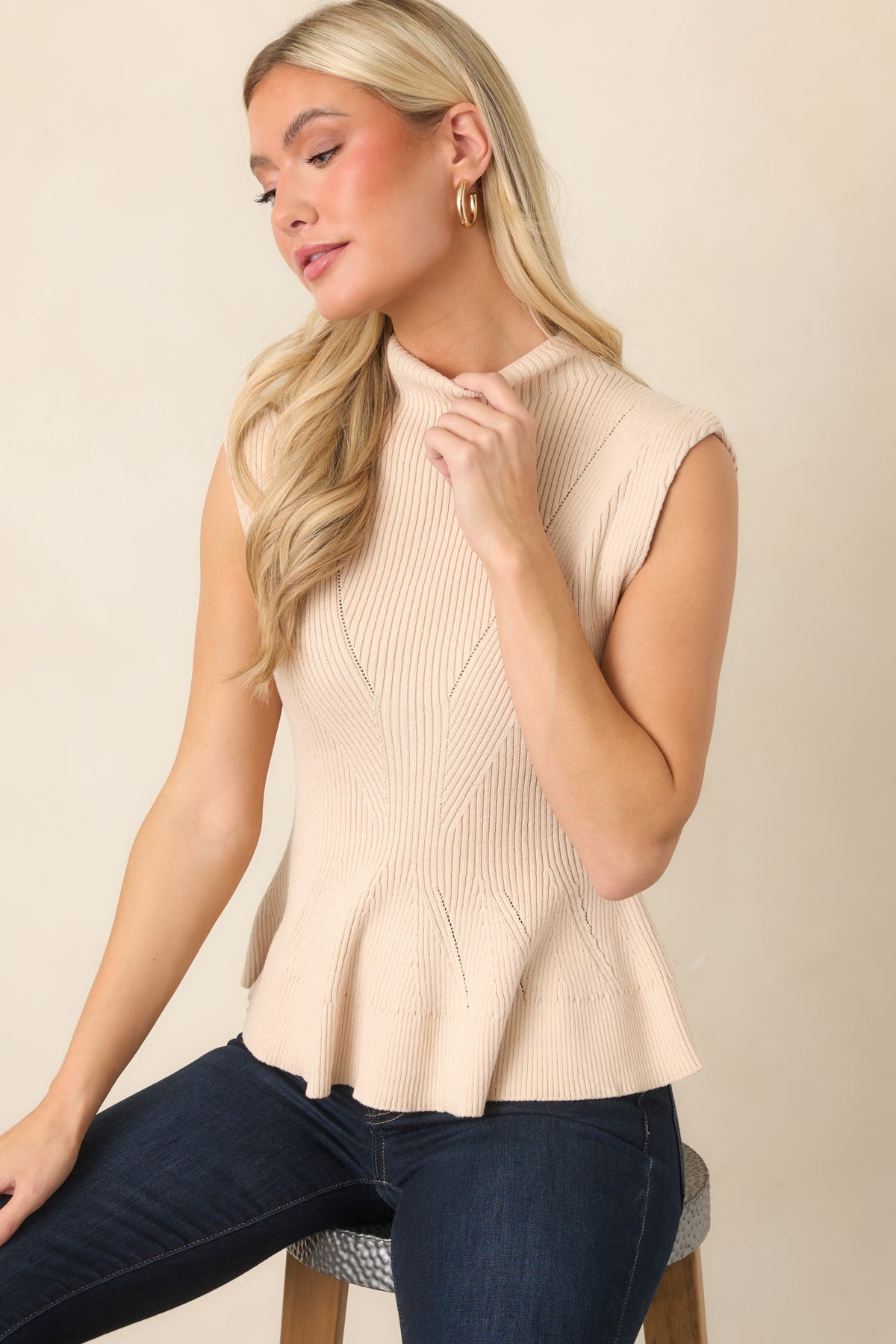 Ecru cotton-blend ribbed knit top with a sleeveless silhouette and sophisticated mock neckline.