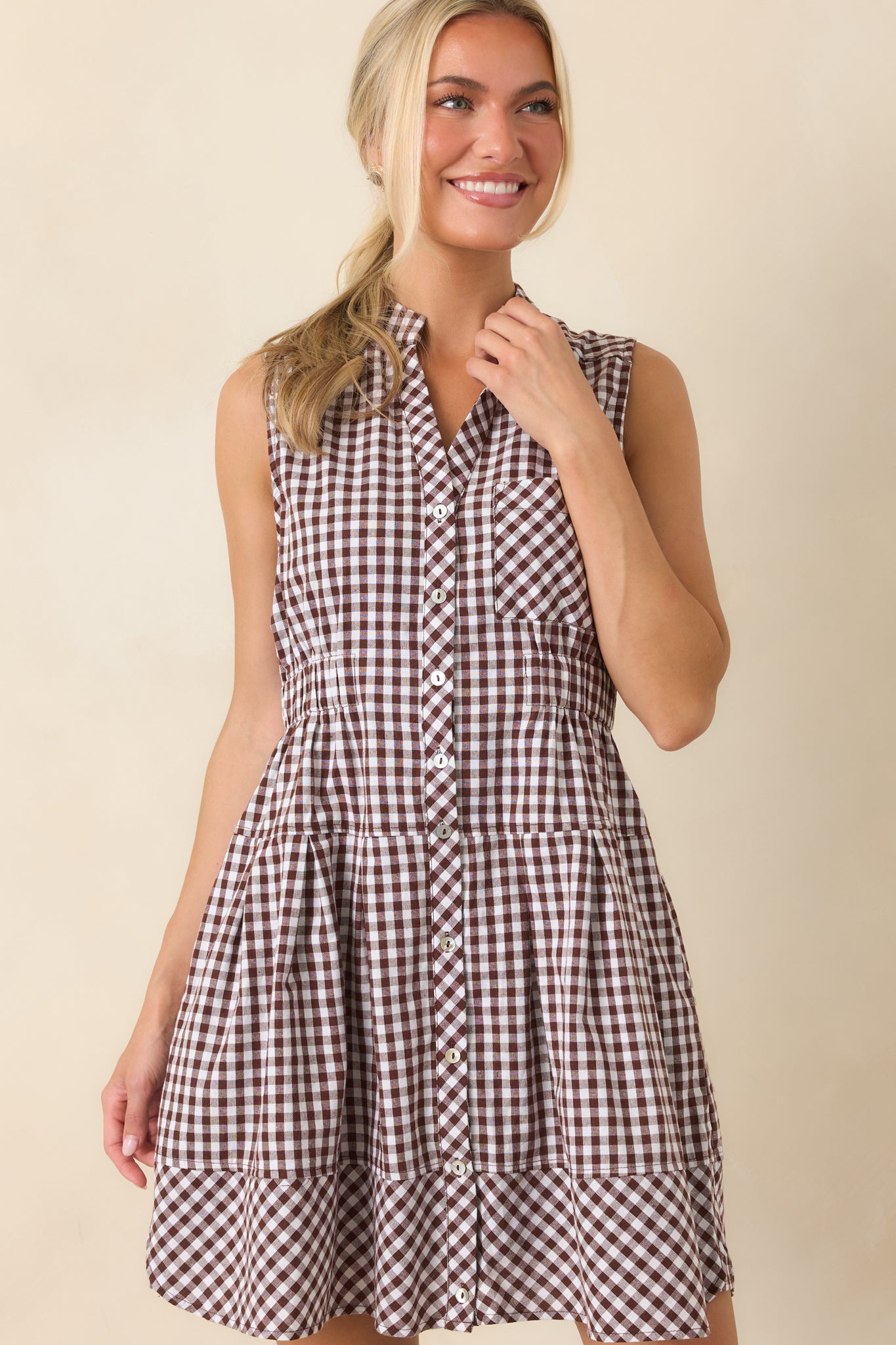 Elastic waistband creates a flattering shape while maintaining the easy fit of this gingham mini dress.