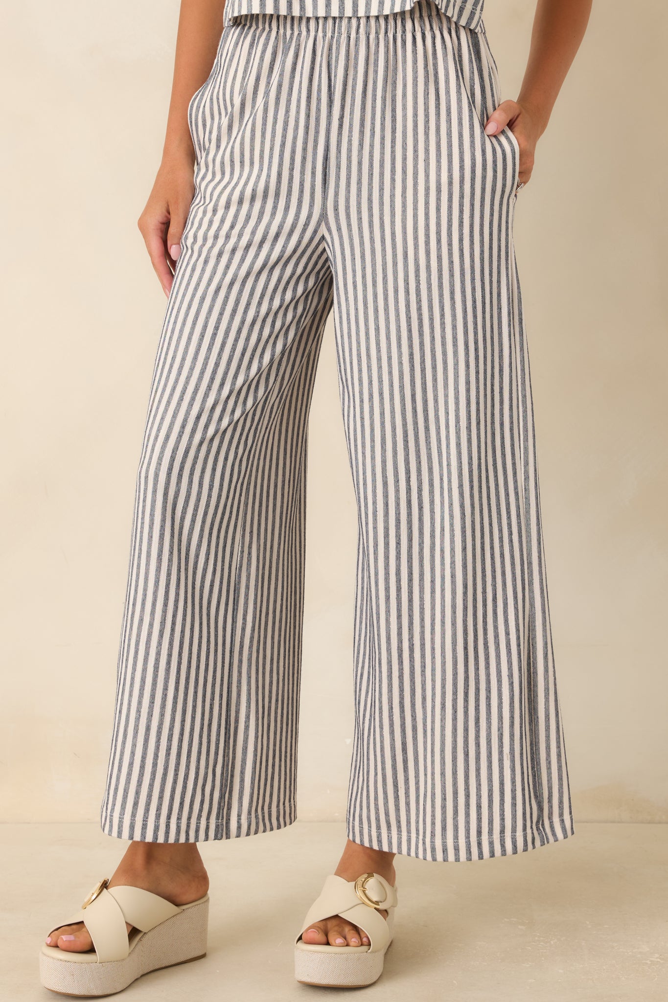 Detailed view of the elastic waistband and navy ivory stripe pattern on cotton knit pants.