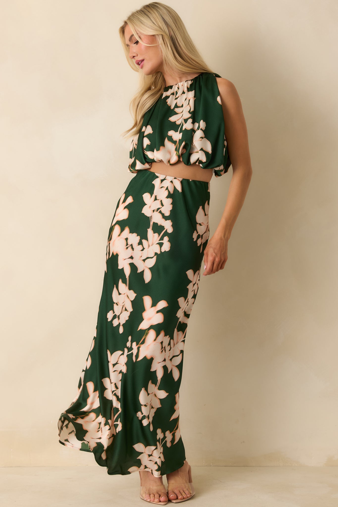 The elasticized hem and halter neckline emphasize the soft, flowing shape and delicate floral print.