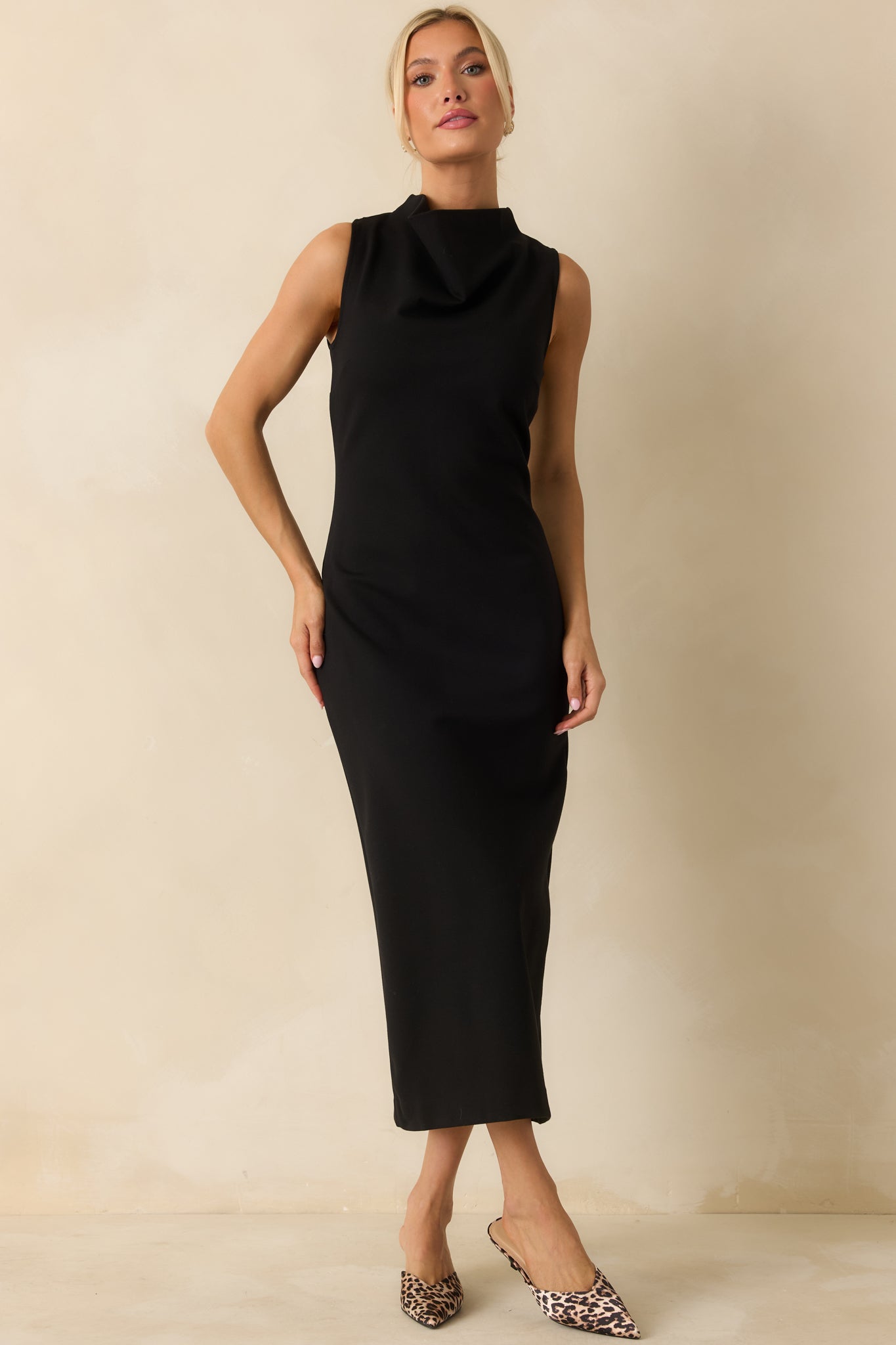 Elegant black midi dress with a high neckline and stretchy ponte fabric, hugging the body for a tailored, streamlined fit.