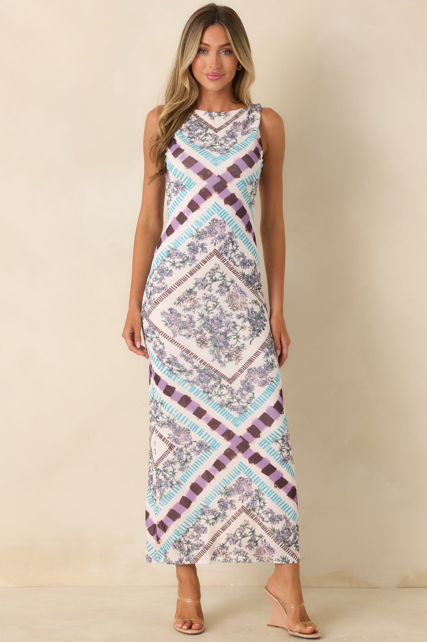 Elegant column midi dress with a vintage floral pattern and a refined, flowing shape.