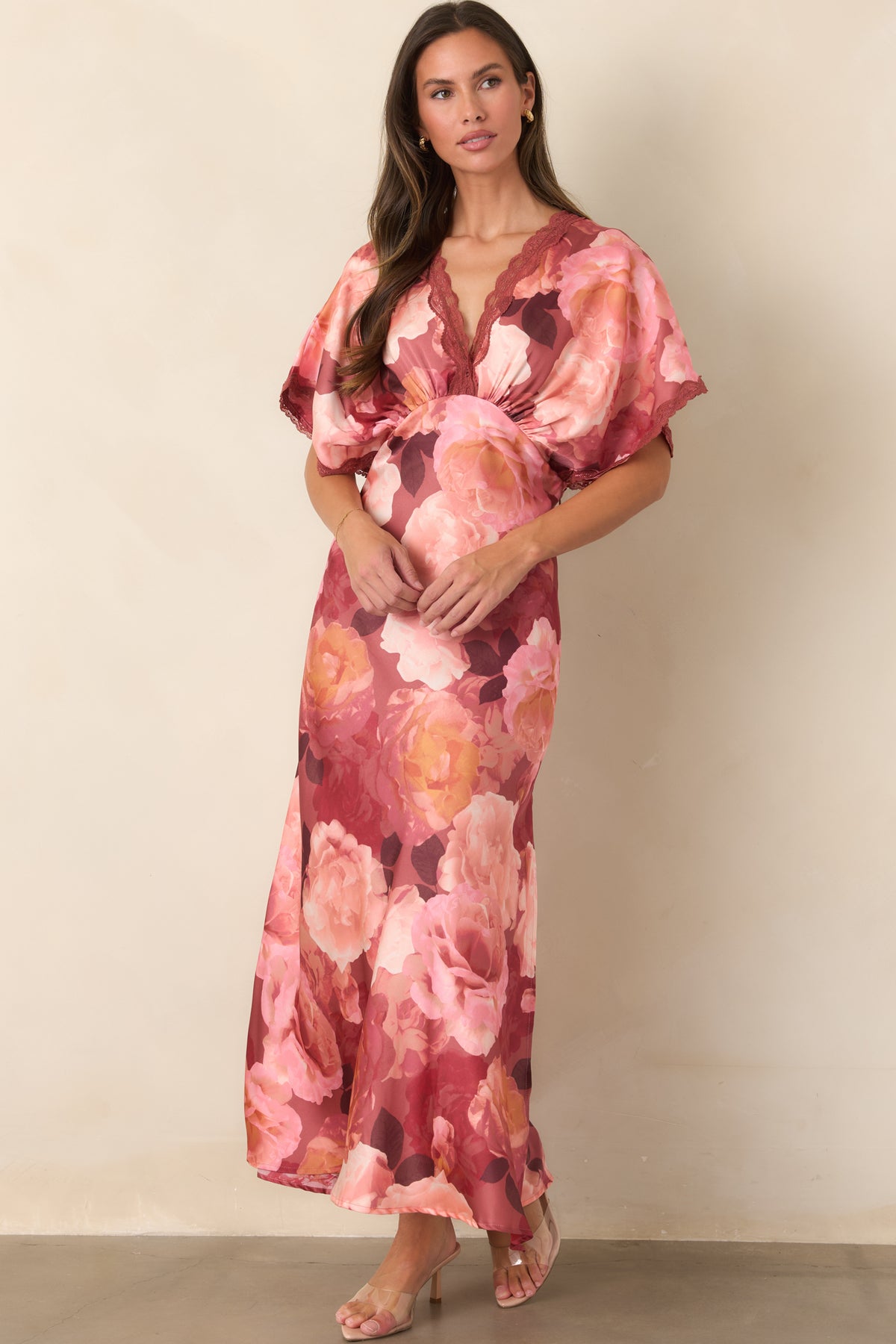 Elegant floral maxi dress featuring a defined waist, delicate lace trim, and lustrous satin construction.