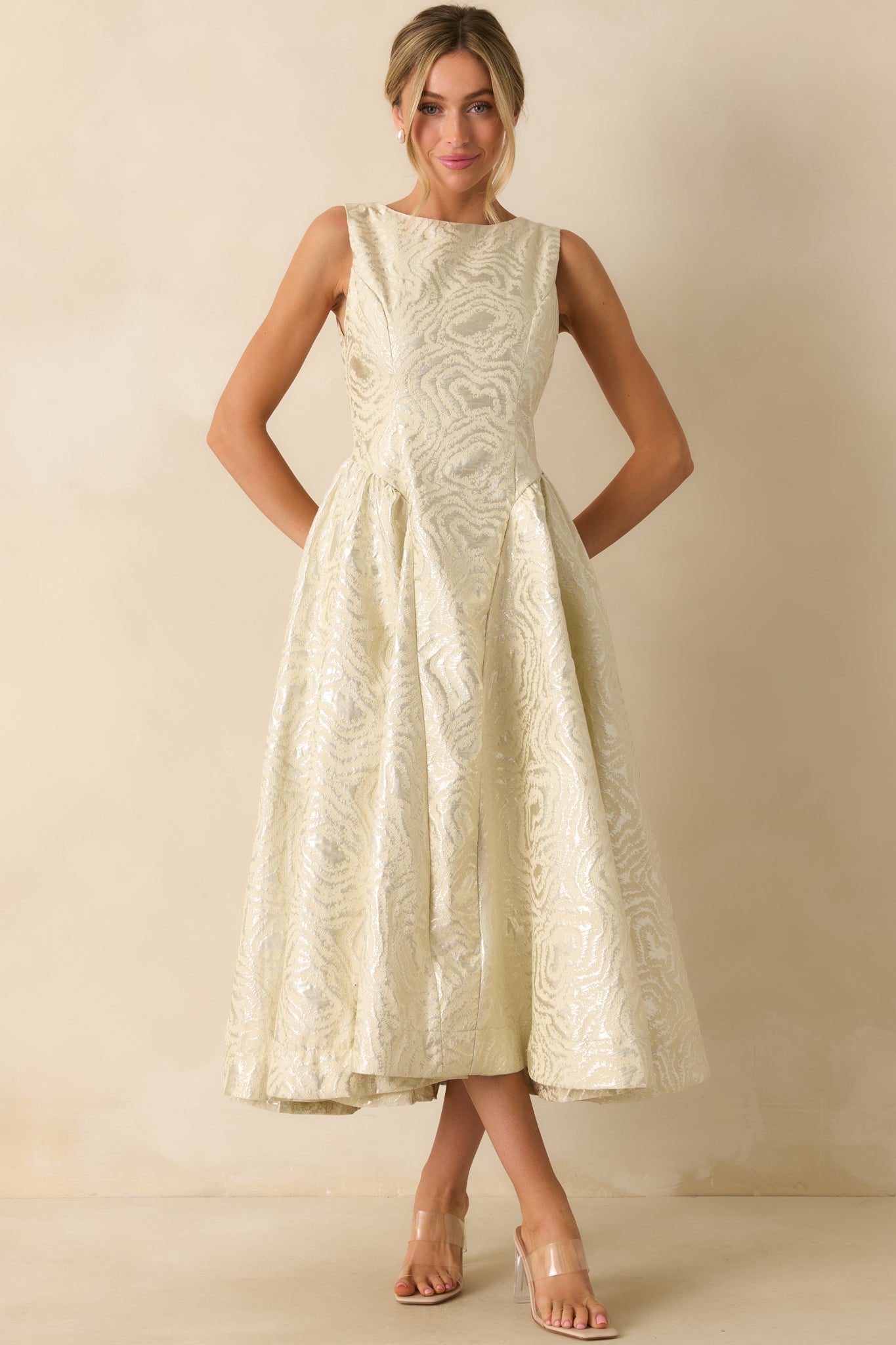 Elegant ivory jacquard dress showcasing its defined waistband and polished, structured silhouette.