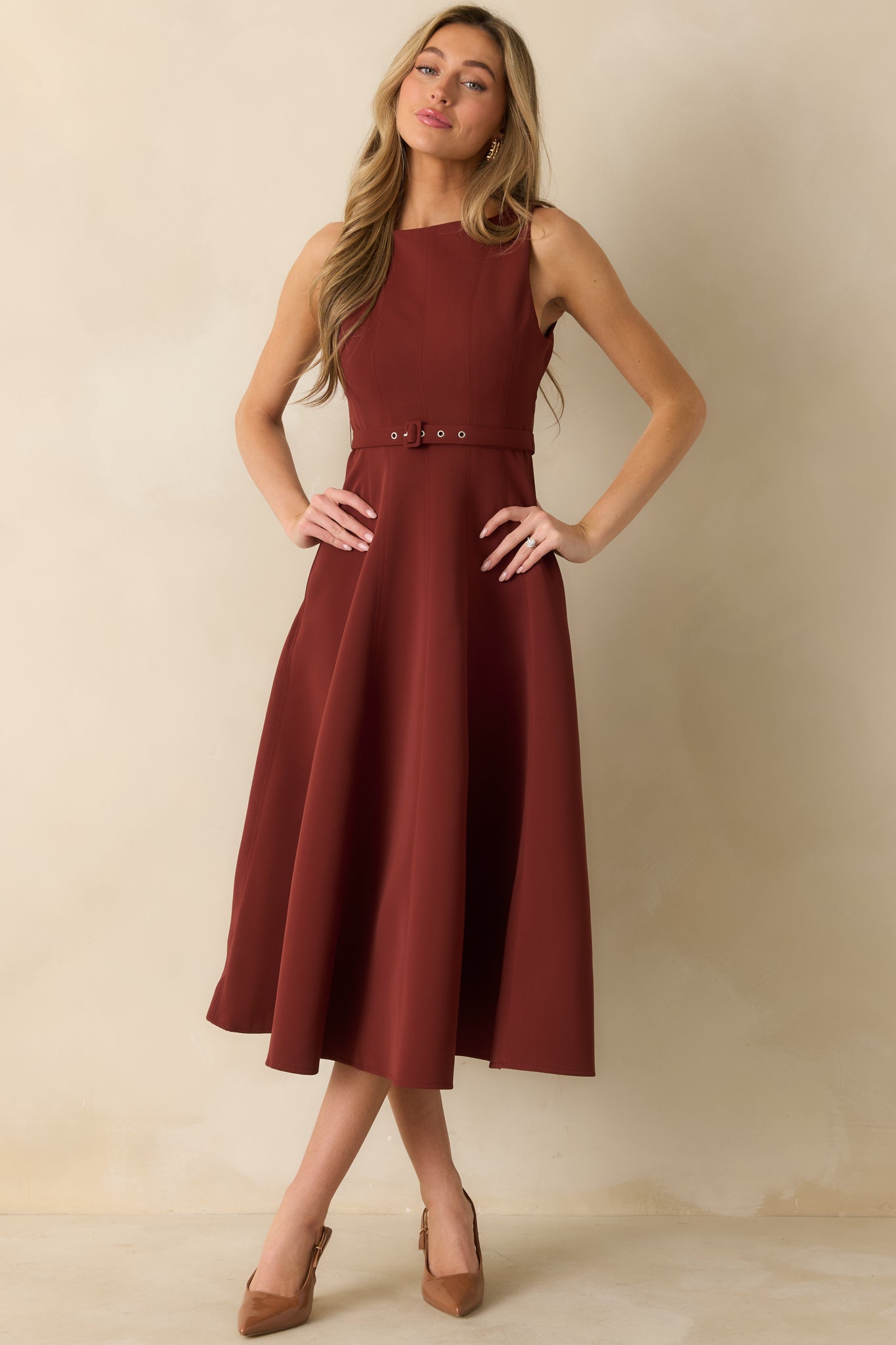 Elegant midi dress in wine red highlighting structured bodice seams and a flattering A-line silhouette.